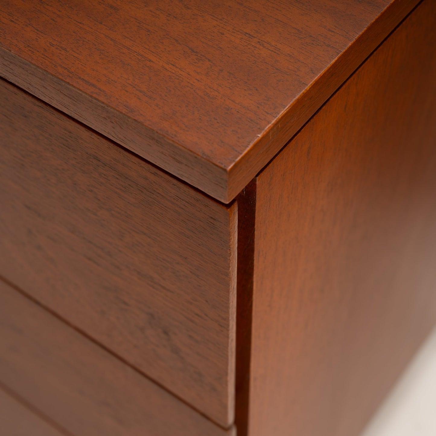Florence Knoll Walnut Chest of Drawers close detail showing warm walnut grain flush drawer fronts and crisp overhanging corner joinery in mid century modern furniture style