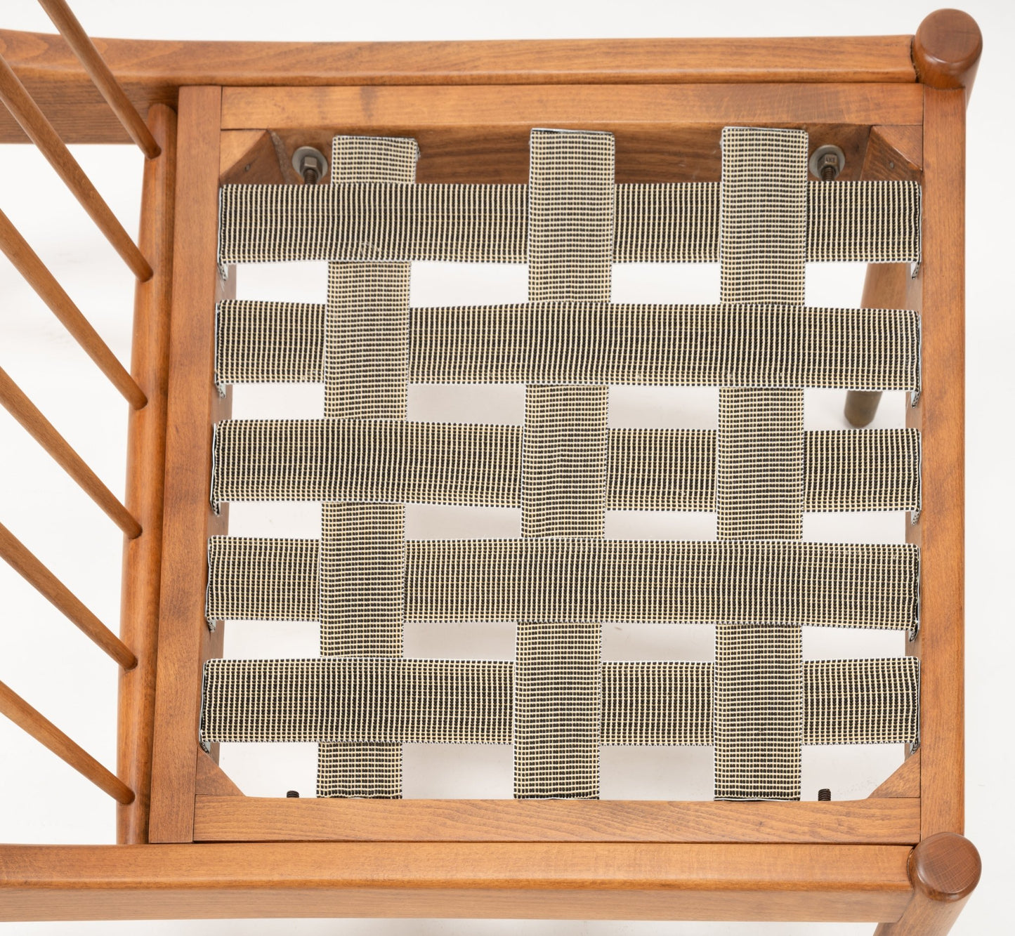 Overhead view of Folke Ohlsson slipper chair showing tightly woven beige webbing seat on beechwood frame