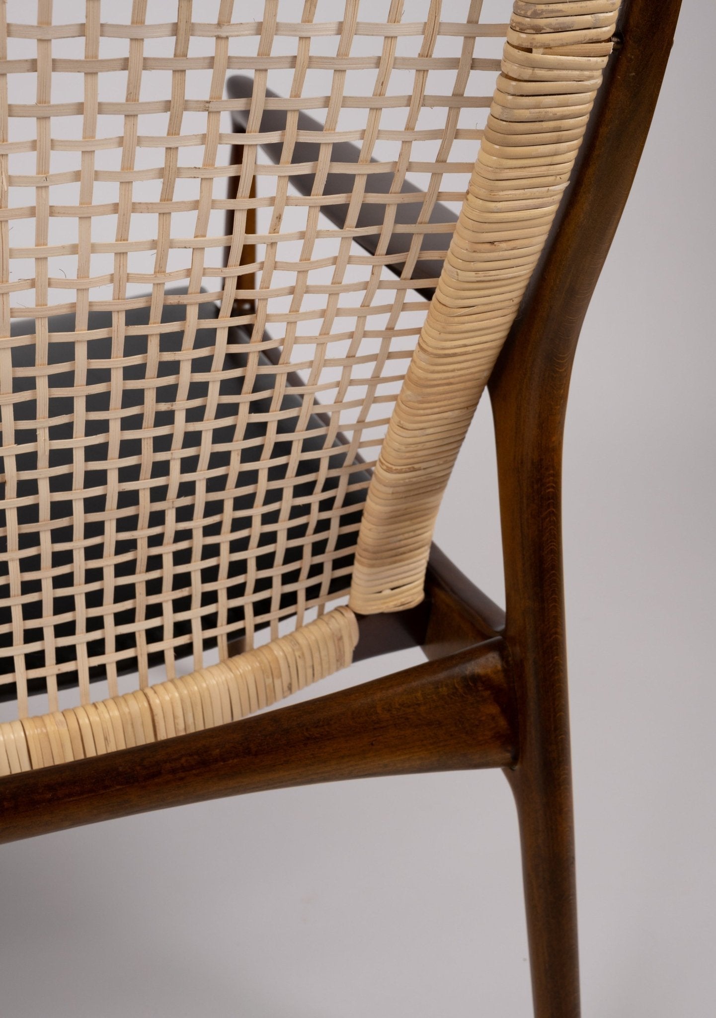 Close-up of Ib Kofod Larsen model 18-15 chair cane backrest with solid teak frame and original faux leather seat