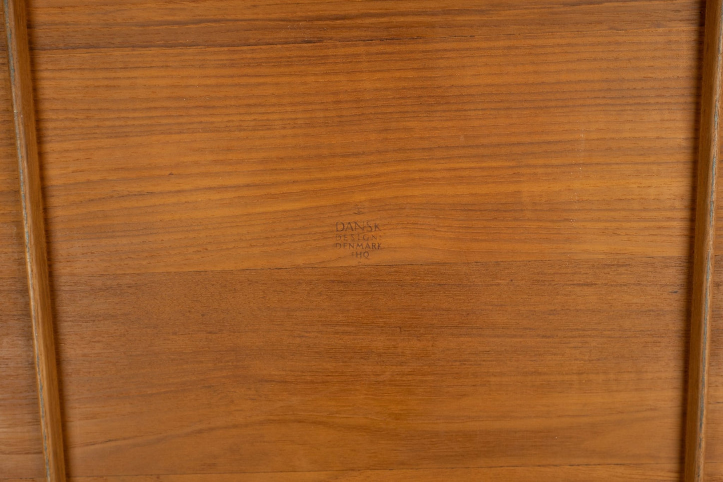 Underside of Jens Quistgaard 1950s oval teak tray with Dansk Denmark four ducks logo branding visible