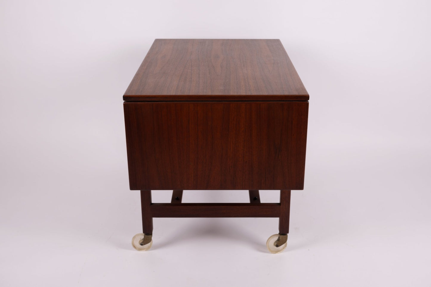 1960s Jens Risom expandable serving cart with walnut finish and casters, shown with leaves folded down