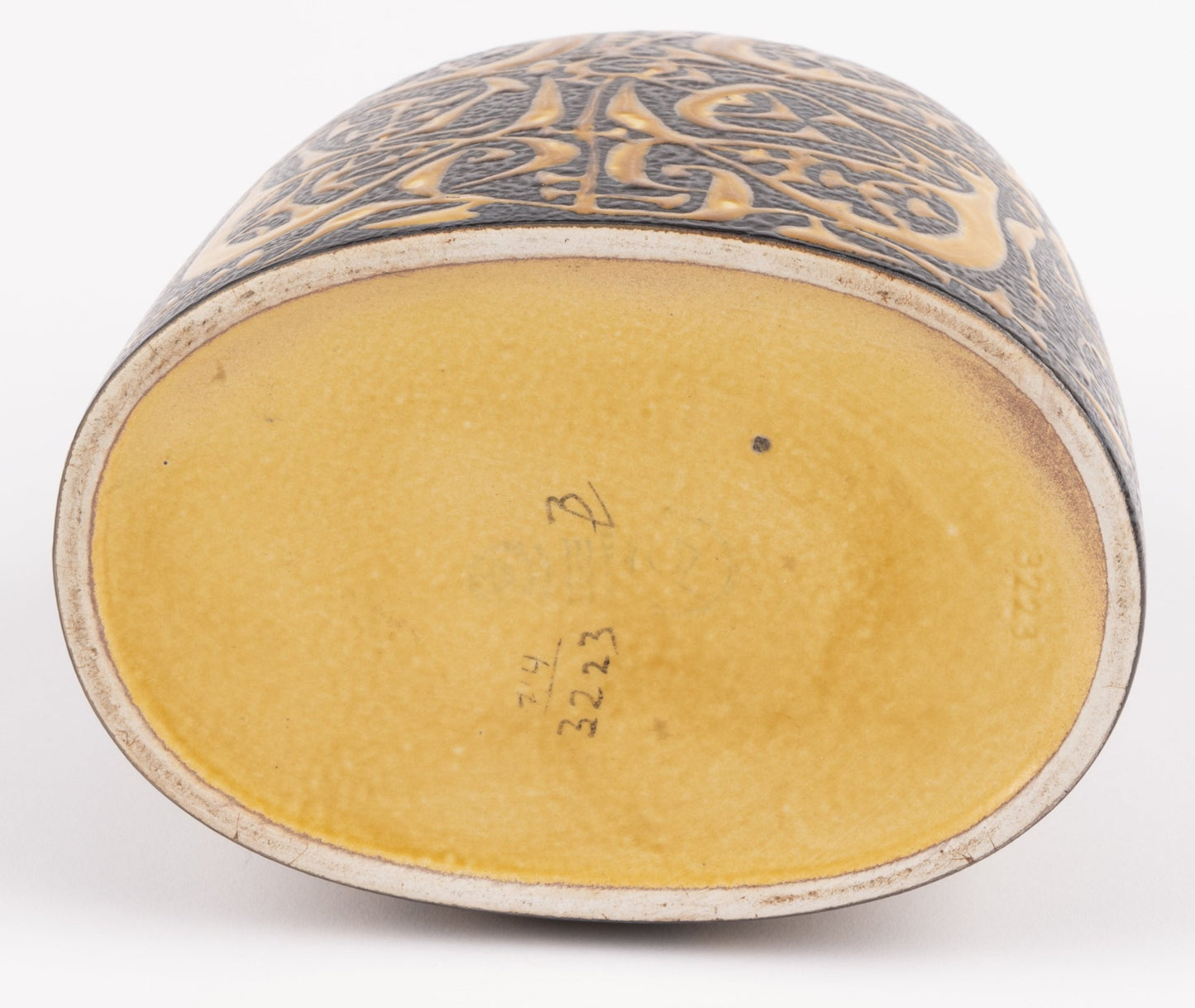 Base view of Nils Thorsson fajance vase showing stamped Royal Copenhagen marks and textured yellow glaze interior