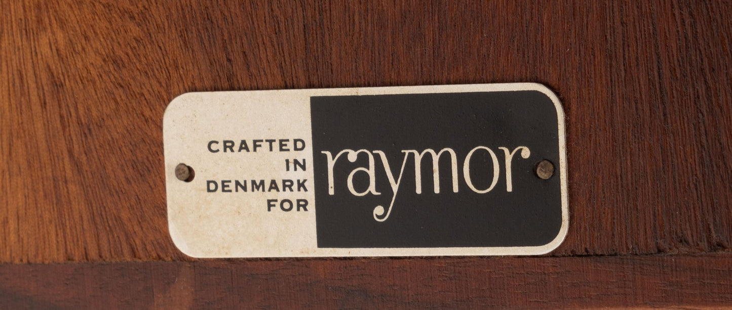 Vintage mid-century Raymor label on teak surface indicating crafted in Denmark by Raymor brand