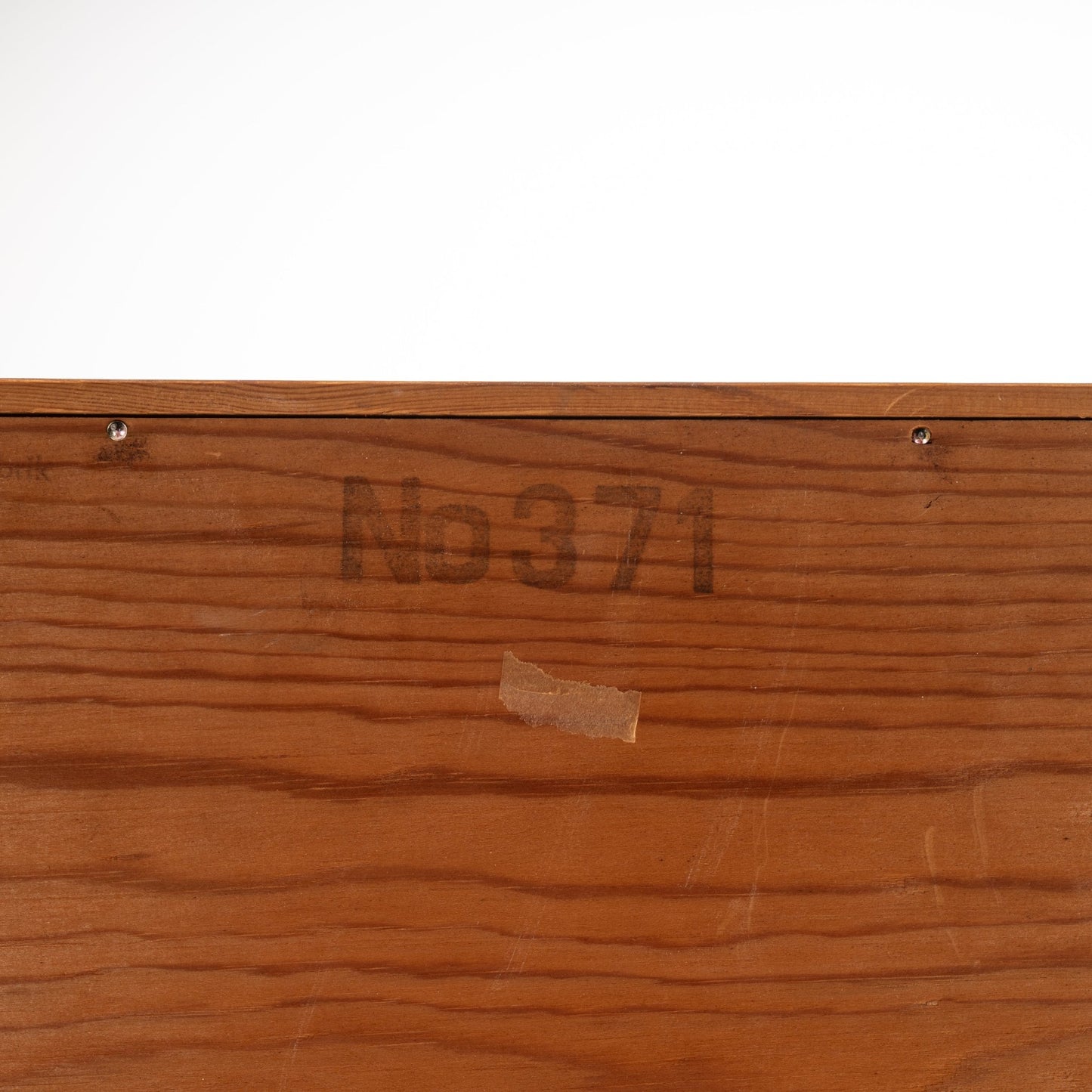 Swedish Teak Cabinet & Bookcase - Set 1 showing a close-up of the wood surface with a faded stamped number and fine teak grain, highlighting vintage mid century modern craftsmanship.