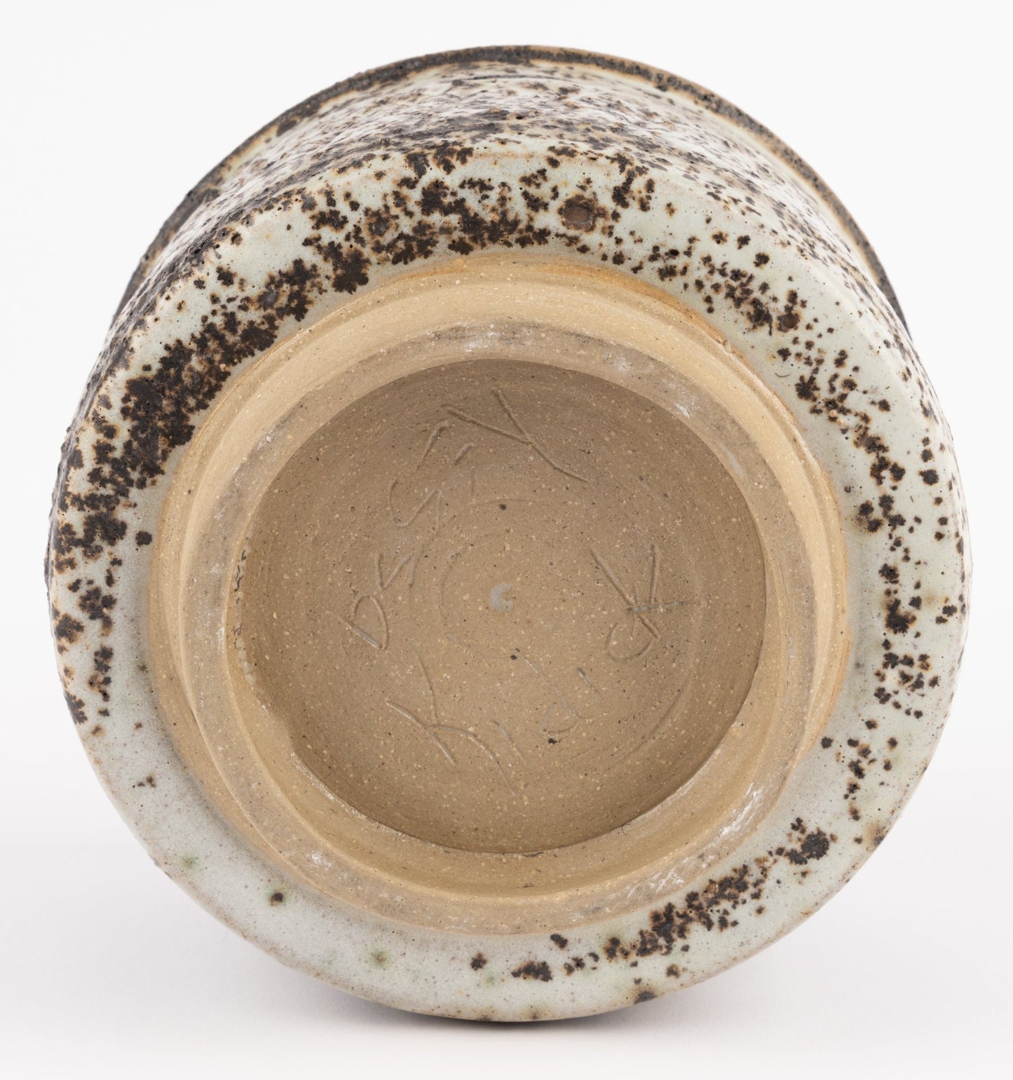 Underside view of Tessa Kidick studio pottery bowl showing unglazed foot and engraved signature on ceramic base