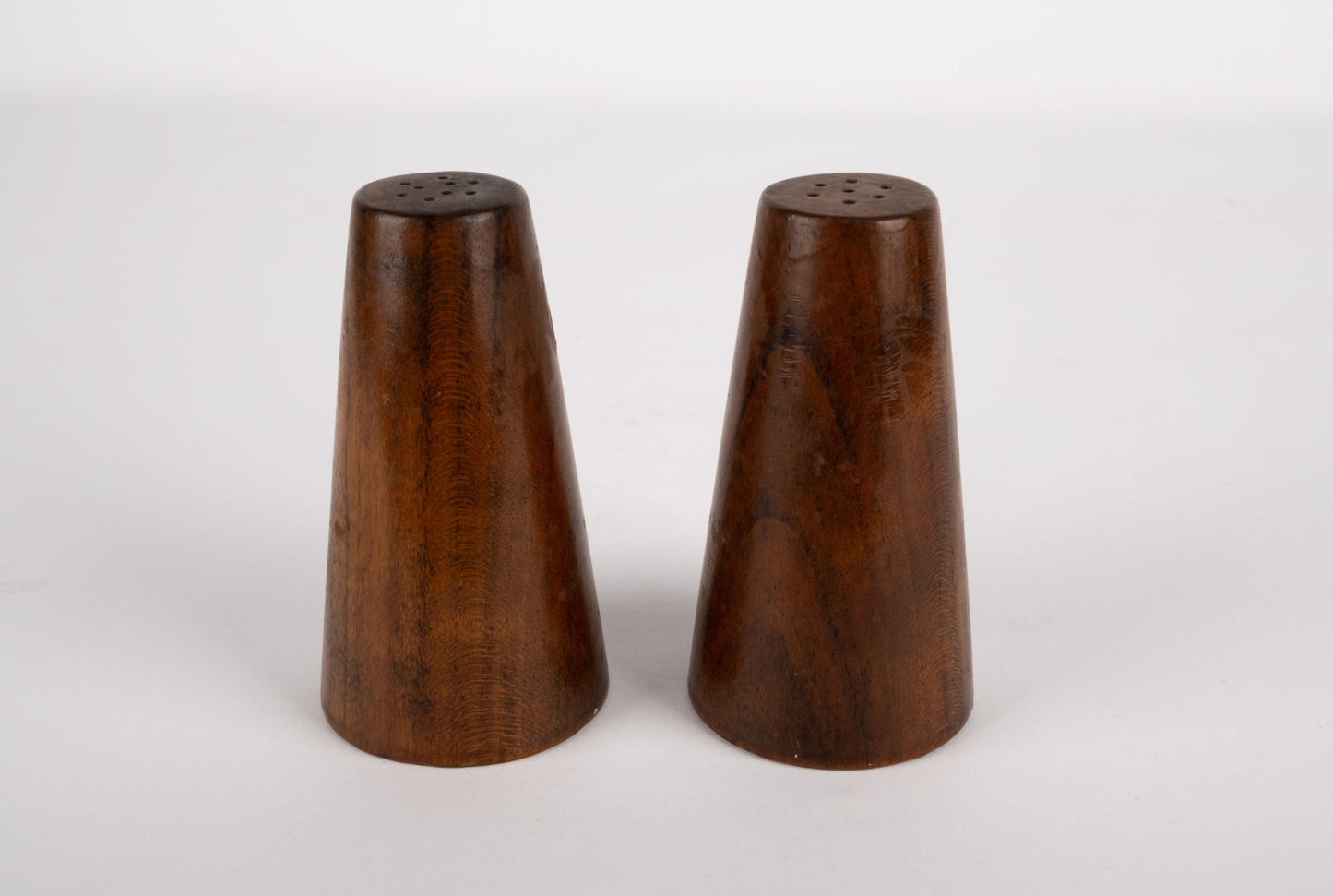 Pair of tapered solid walnut salt and pepper shakers inspired by Paul Evans and Phil Powell with smooth finish