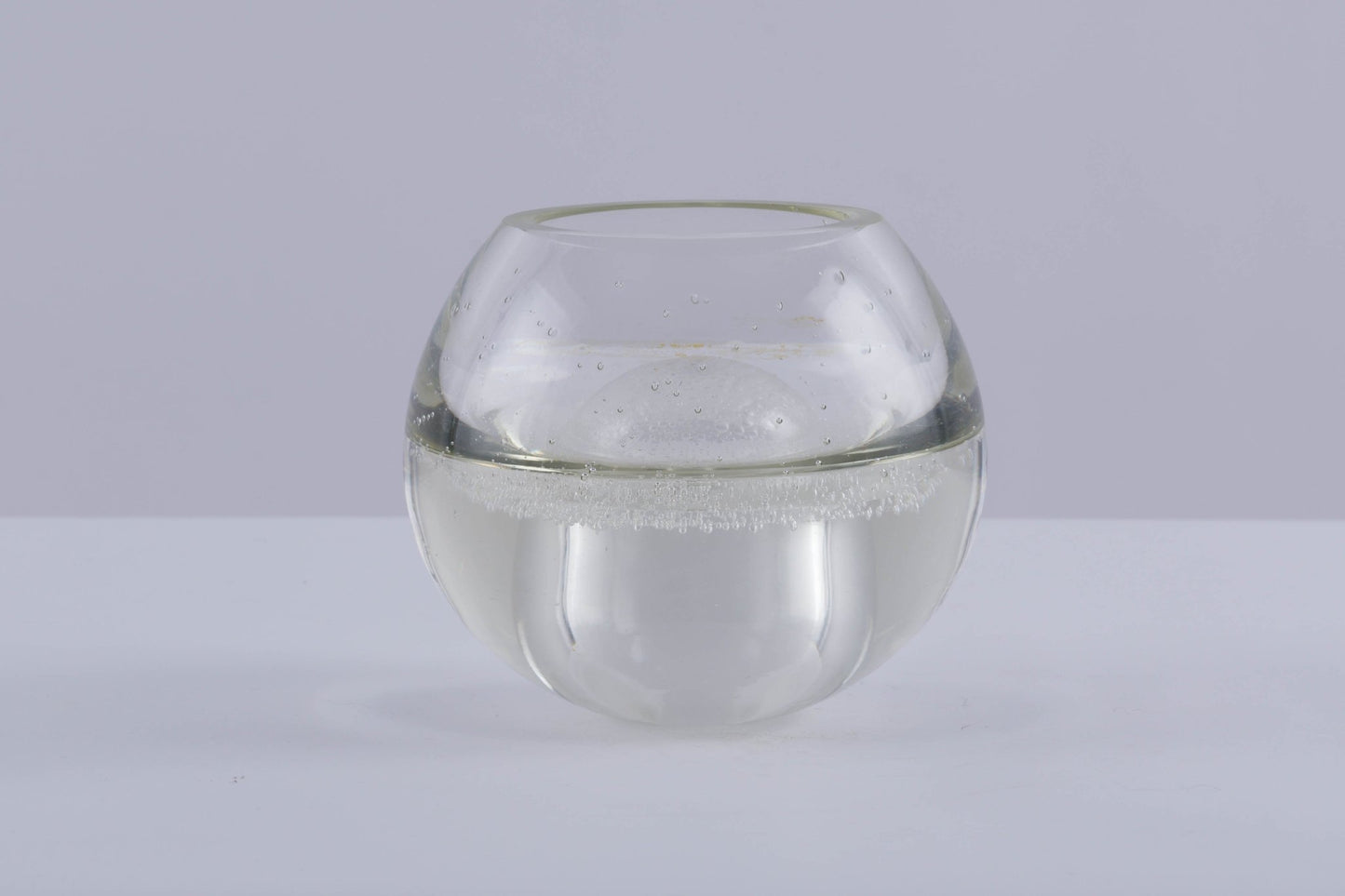 A.D. Copier handblown glass vase with rounded shape and small air bubble details called Spijkerbol on gray background.