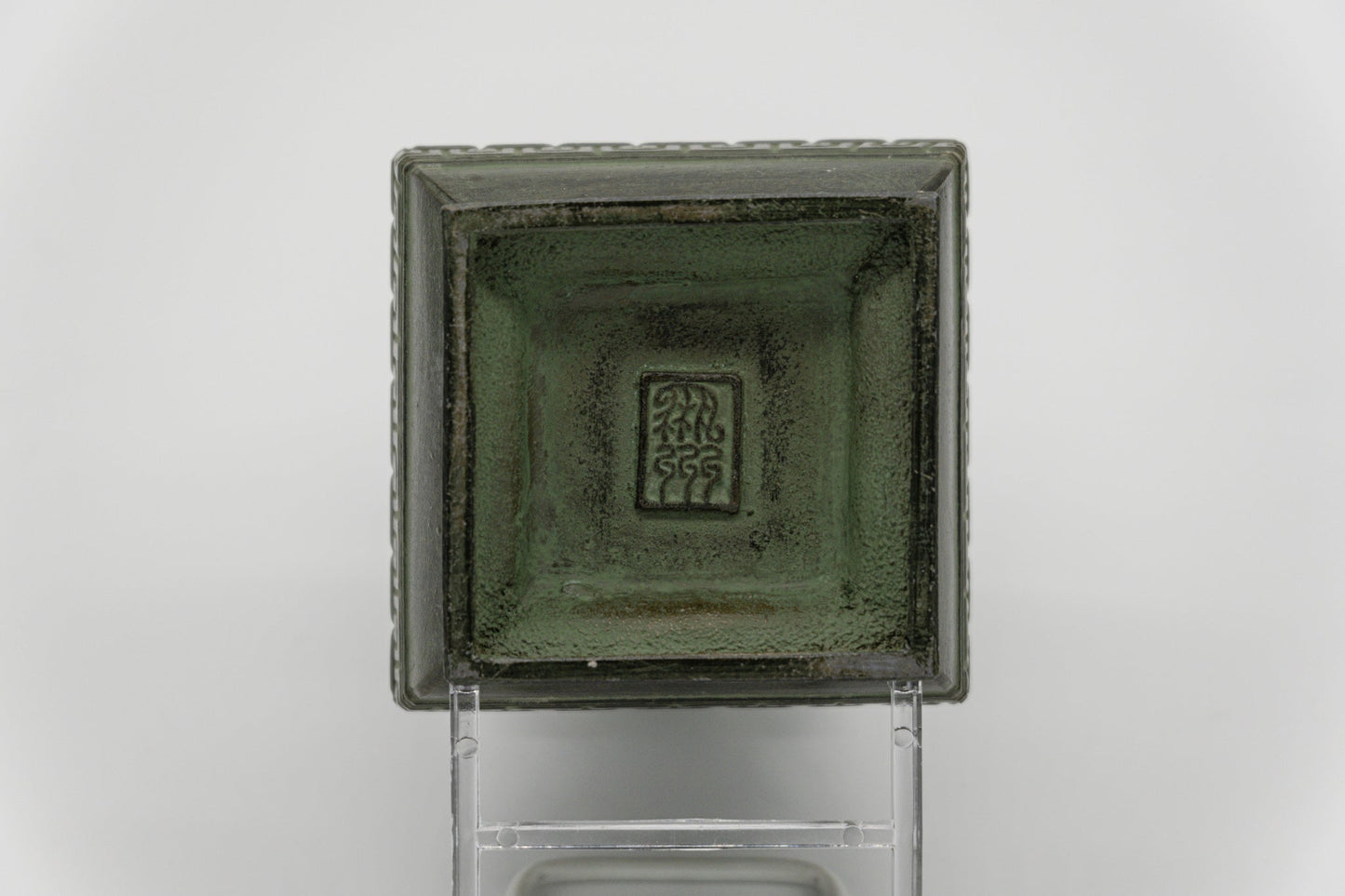 Top view of early 20th century Chinese bronze vase with square shape and detailed central animal-face motif