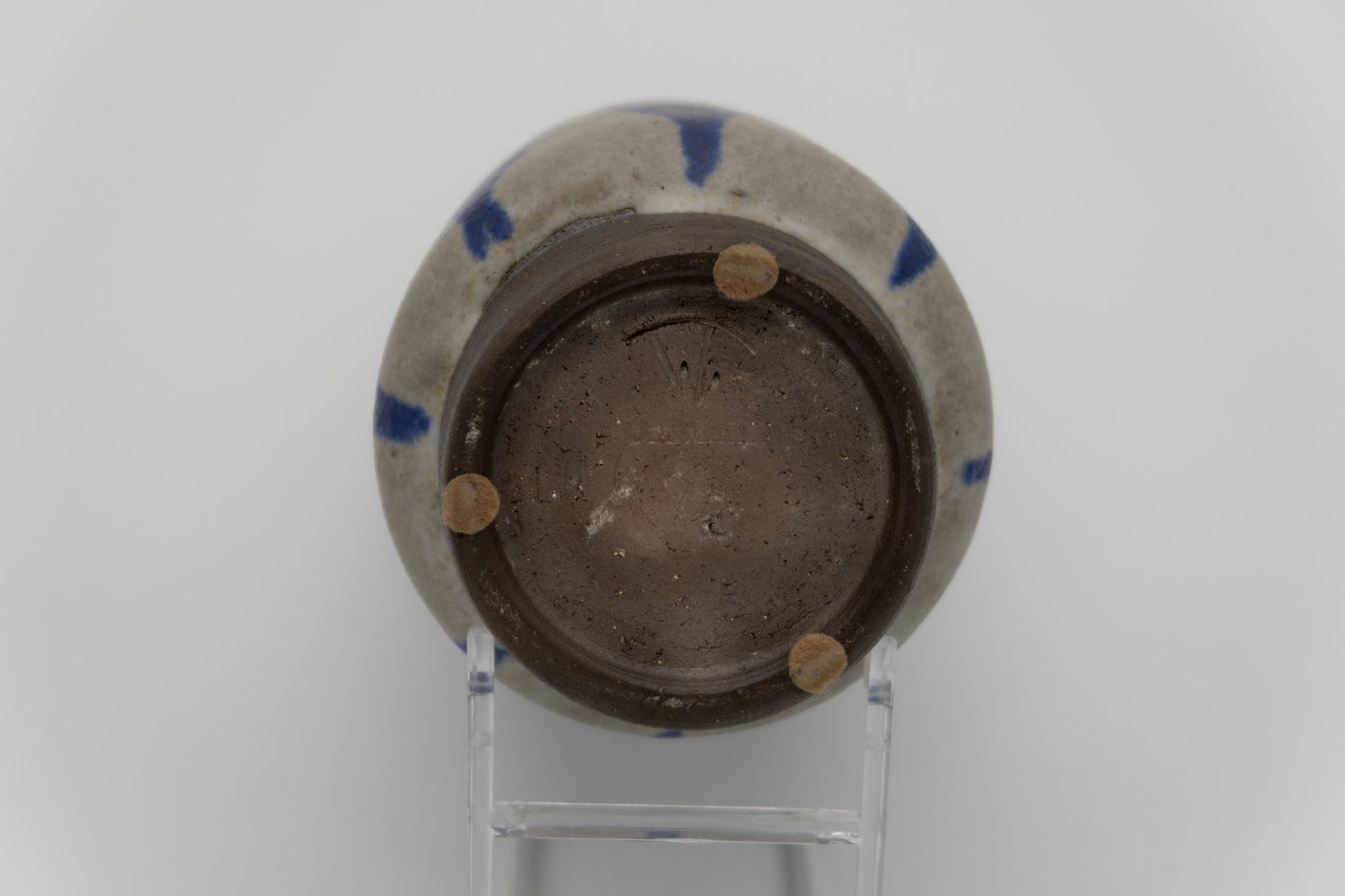 Bottom view of Thomas Toft pottery vase with visible signature and blue abstract glaze on stoneware from Denmark