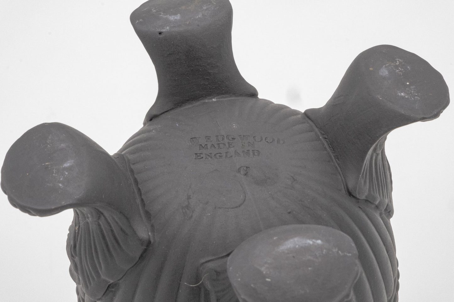 Underside of Wedgwood Solid Black Basalt Vase showing four short feet and embossed maker’s mark from England