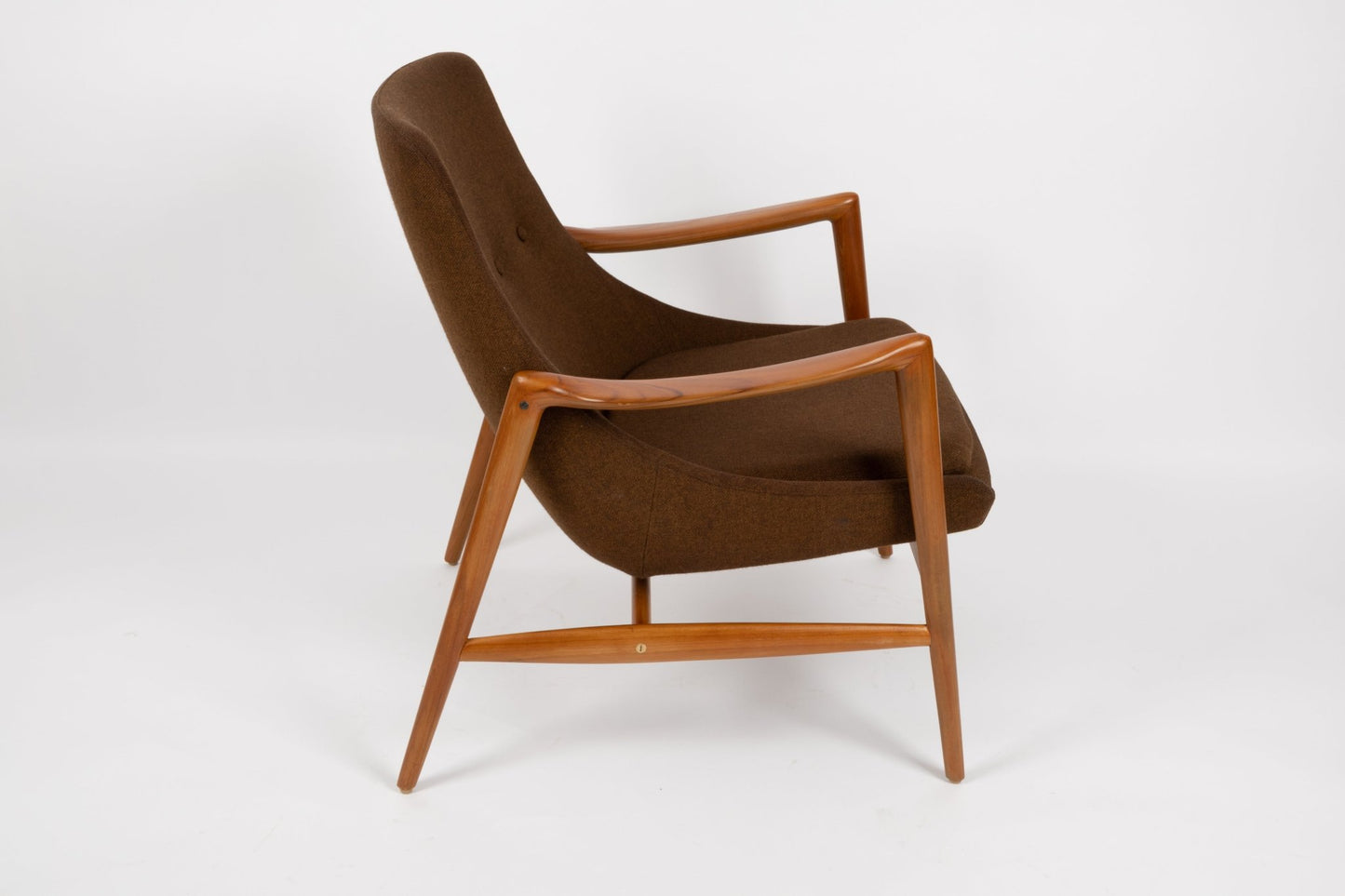 Mid-century modern Adolf Relling lounge chair with sculptural teak frame and brown wool upholstery on white background.