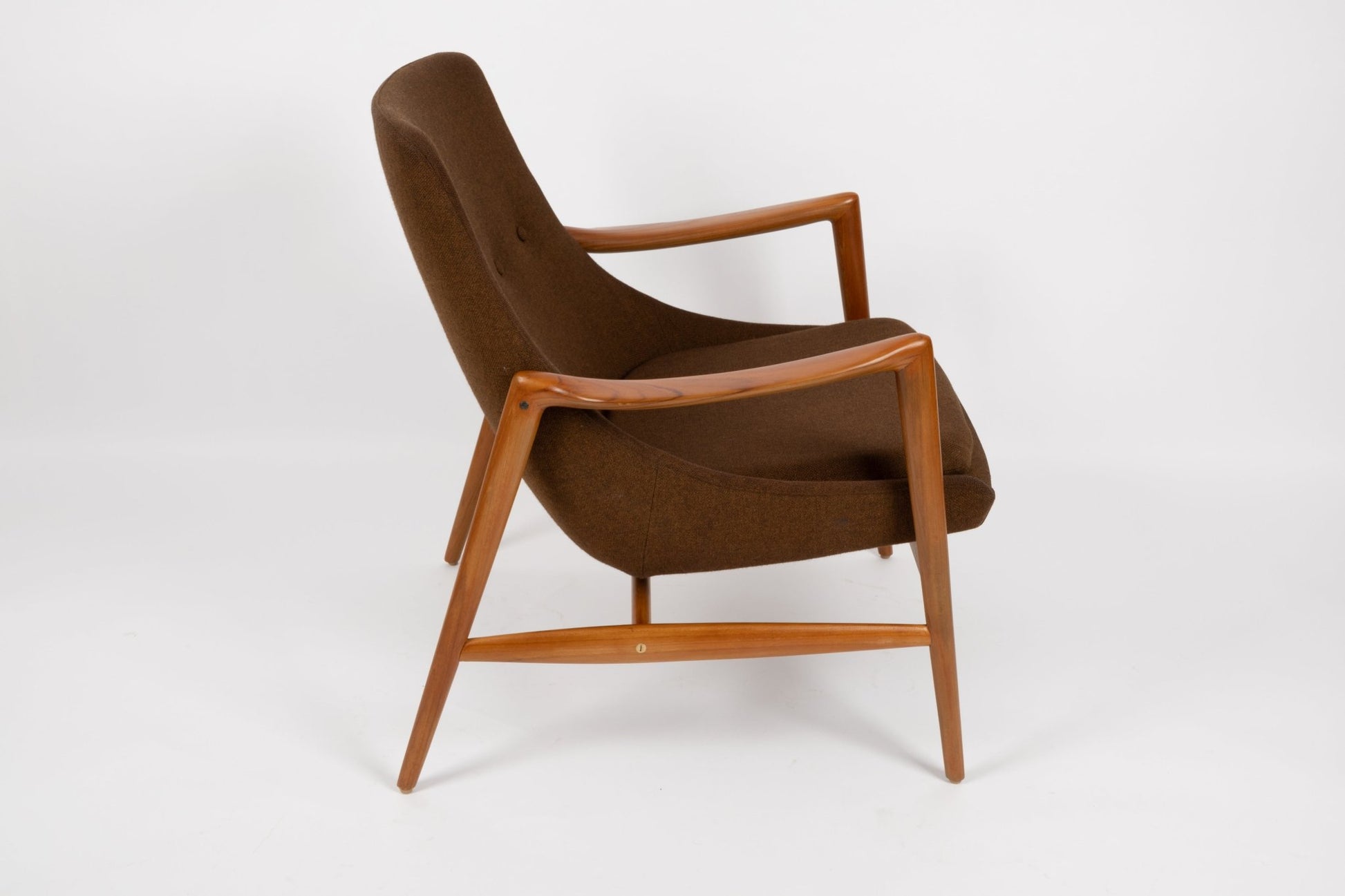 Mid-century modern Adolf Relling lounge chair with sculptural teak frame and brown wool upholstery on white background.
