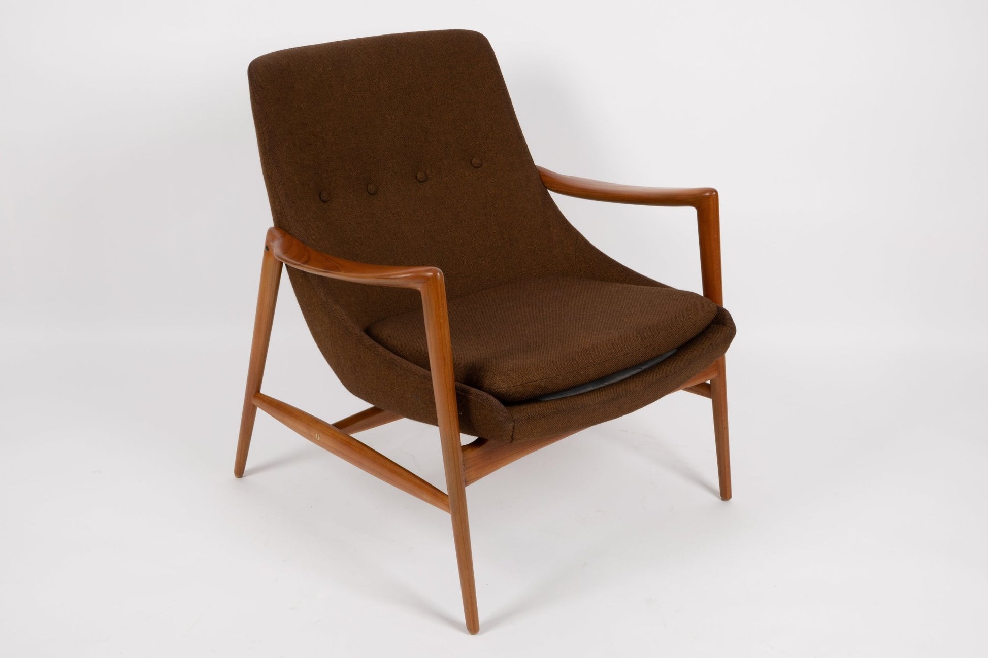 Mid-century modern Adolf Relling lounge chair with sculptural teak frame and brown wool upholstery on white background