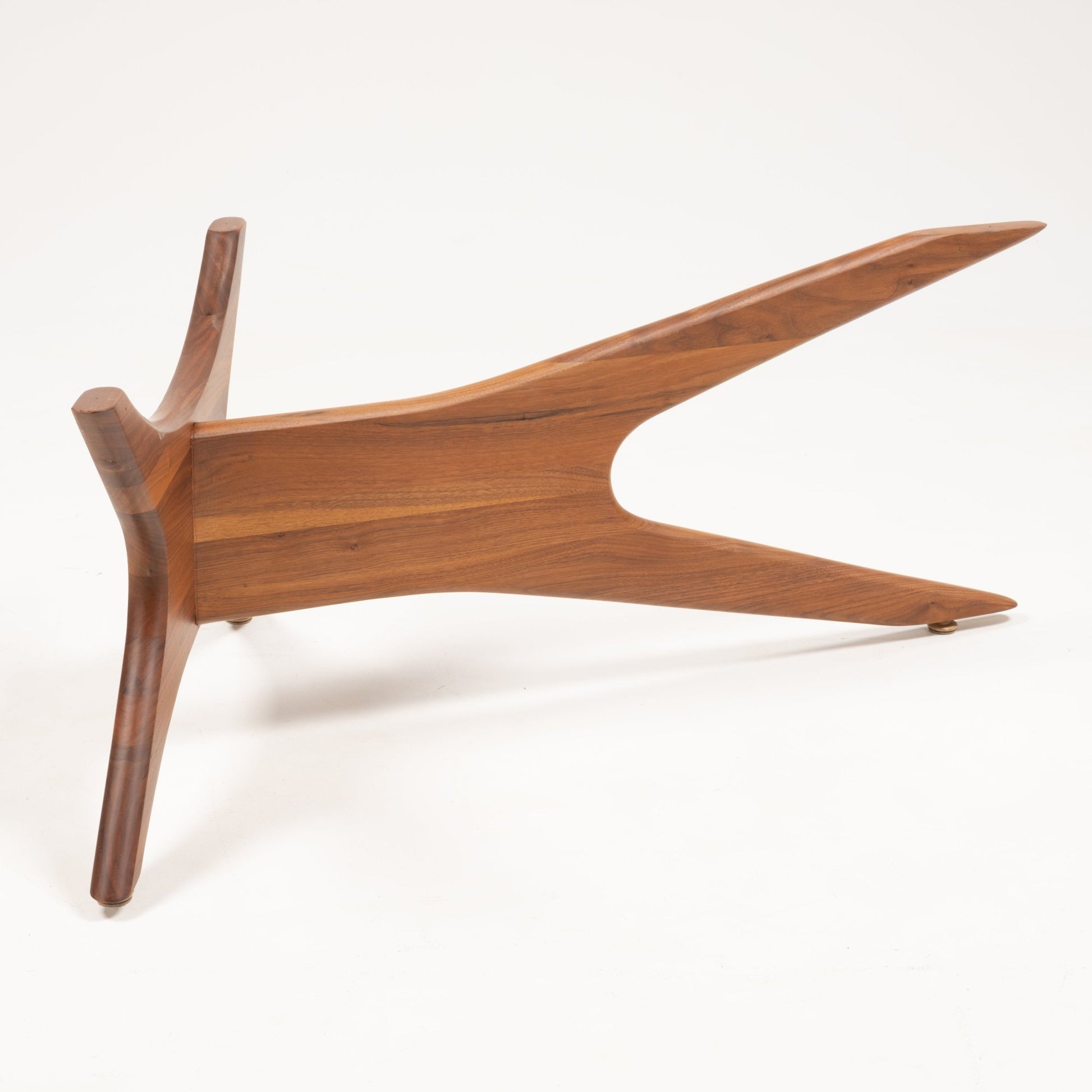 Solid walnut base with four tapered, curved legs in an interlocking jack-inspired design for Adrian Pearsall table