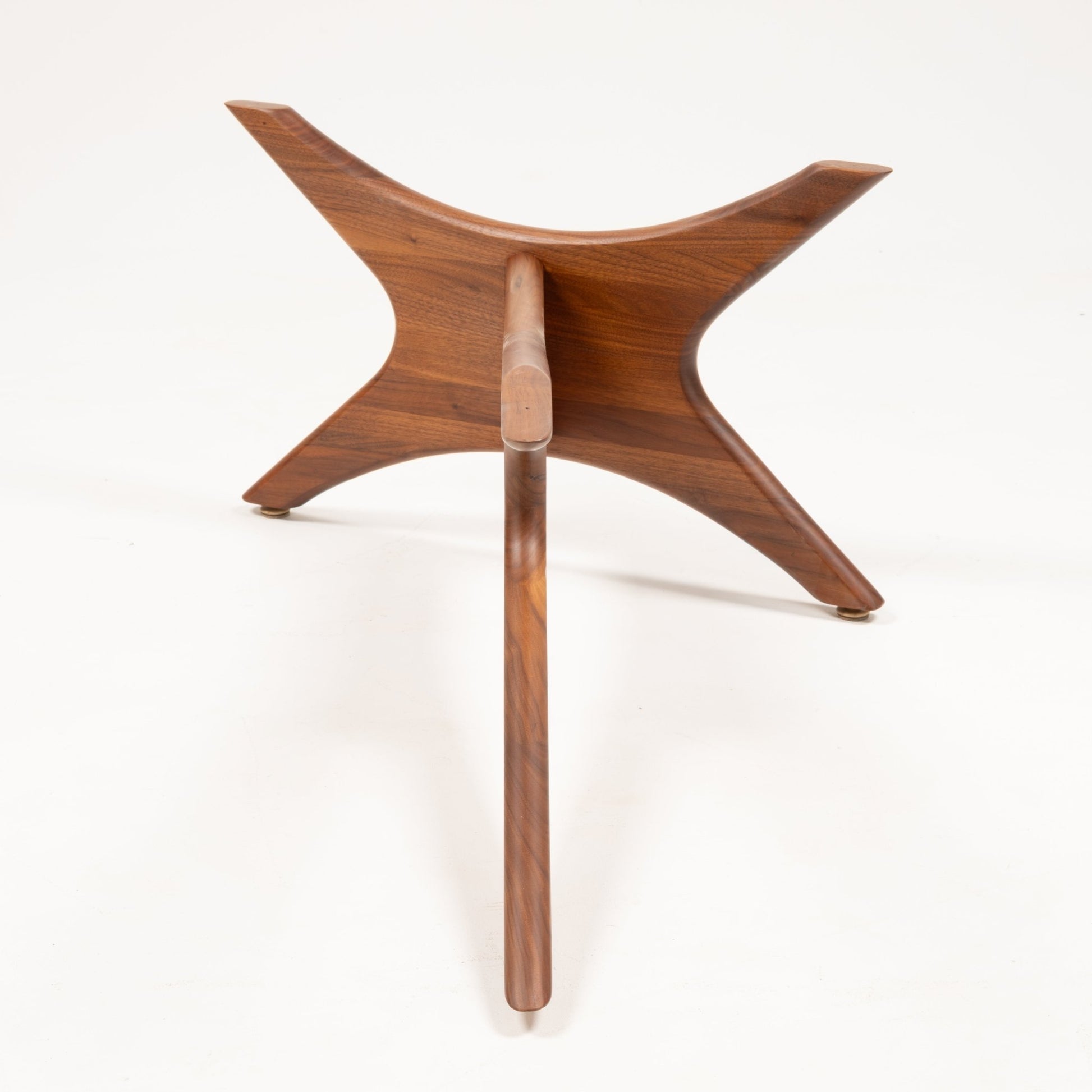 Close-up of solid walnut base with four curved legs interlocked in a star-like pattern for Adrian Pearsall coffee table