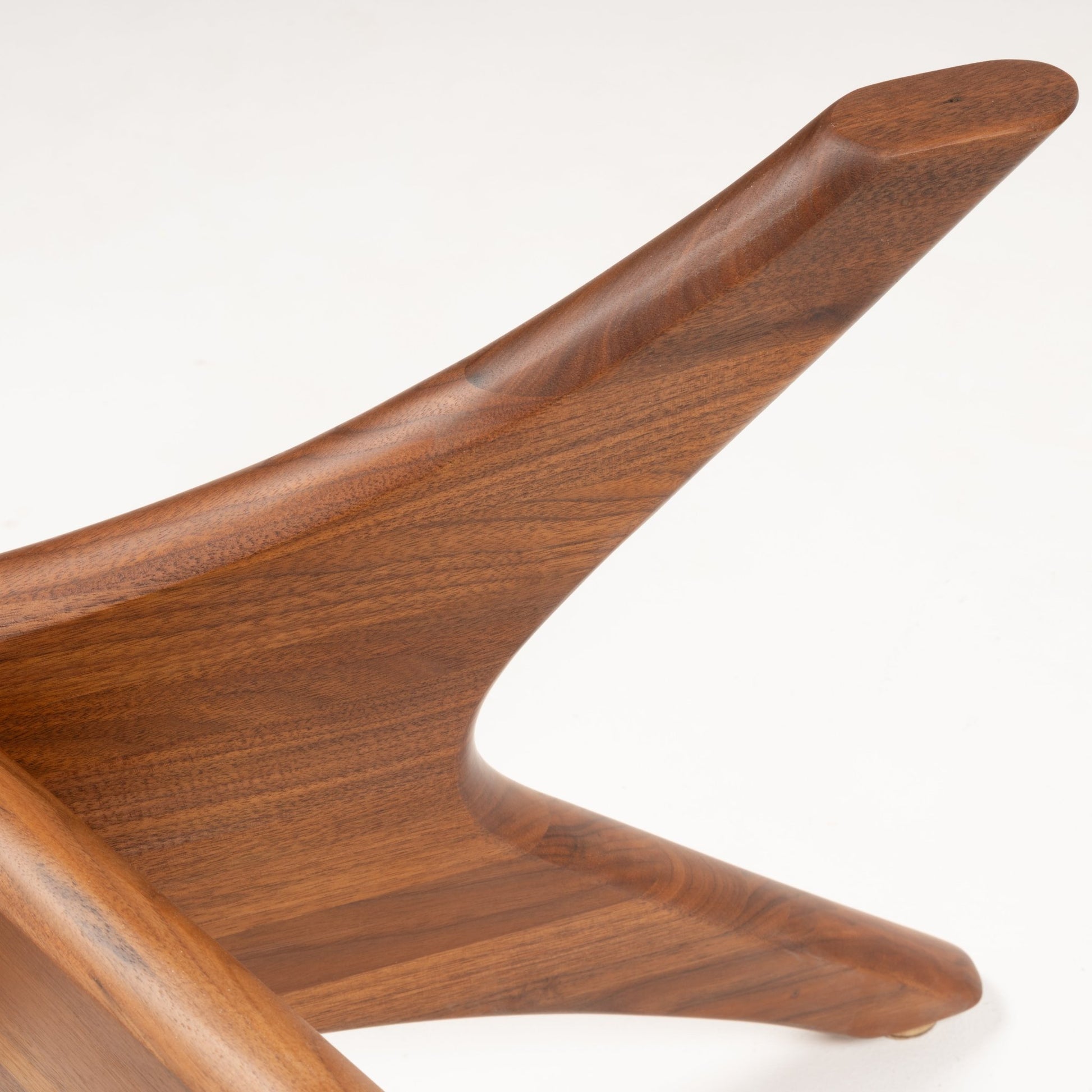Close-up of smooth sculpted solid walnut leg with sleek wood grain from Adrian Pearsall coffee table base