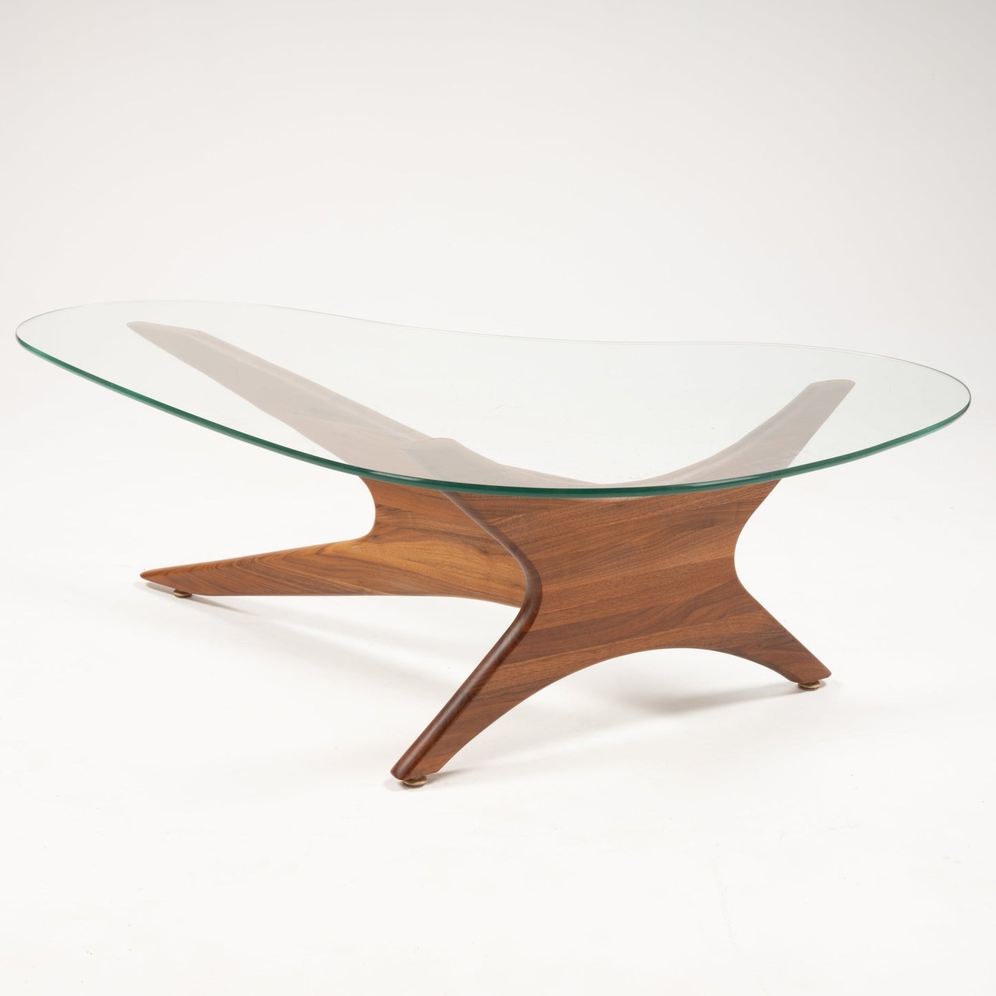 Curved solid walnut base with four interlocking legs supporting asymmetrical glass top of Adrian Pearsall Jacks table