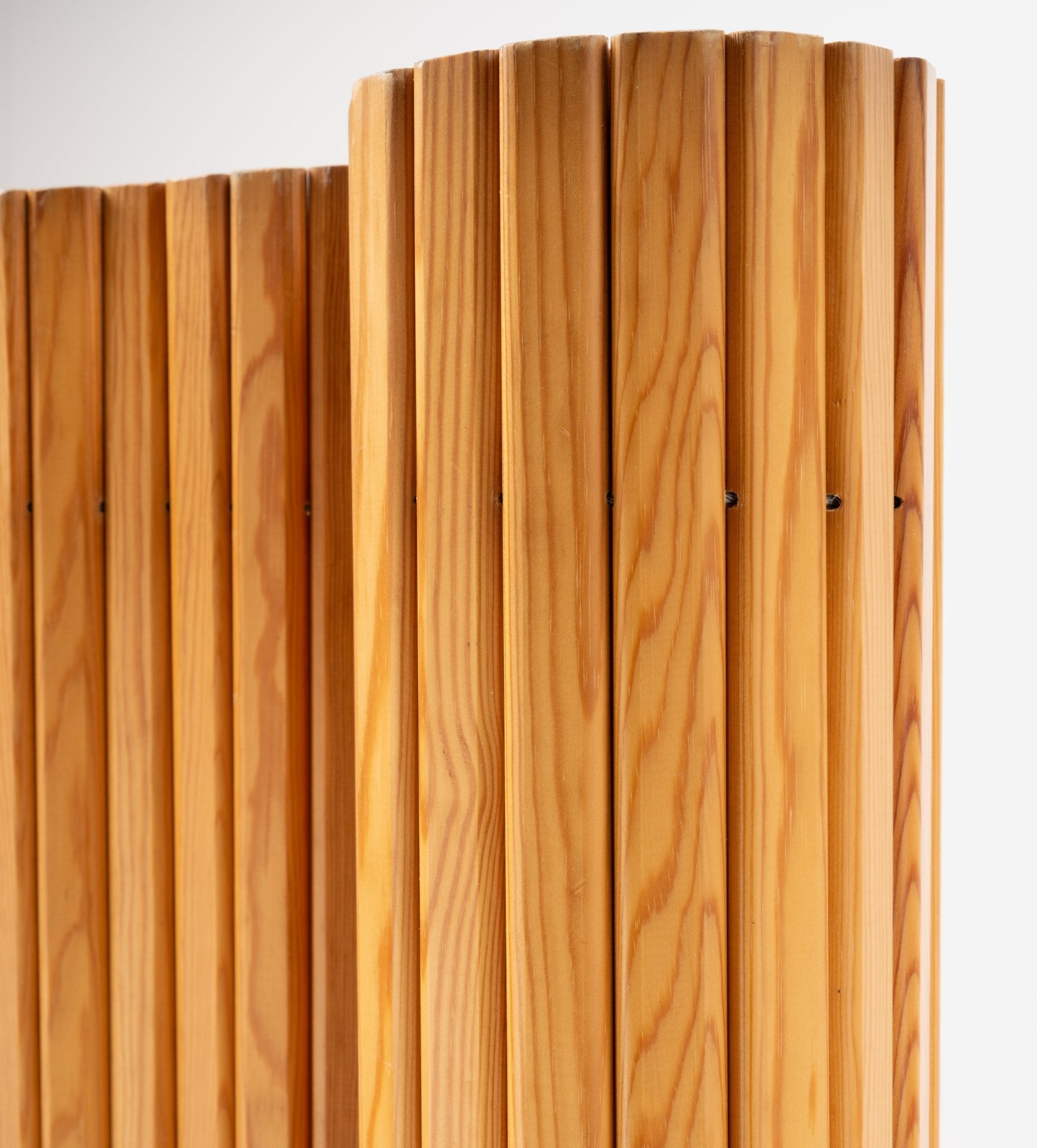 Close-up of Alvar Aalto 'Screen 100' room divider showing smooth vertical pine slats with natural finish on white background