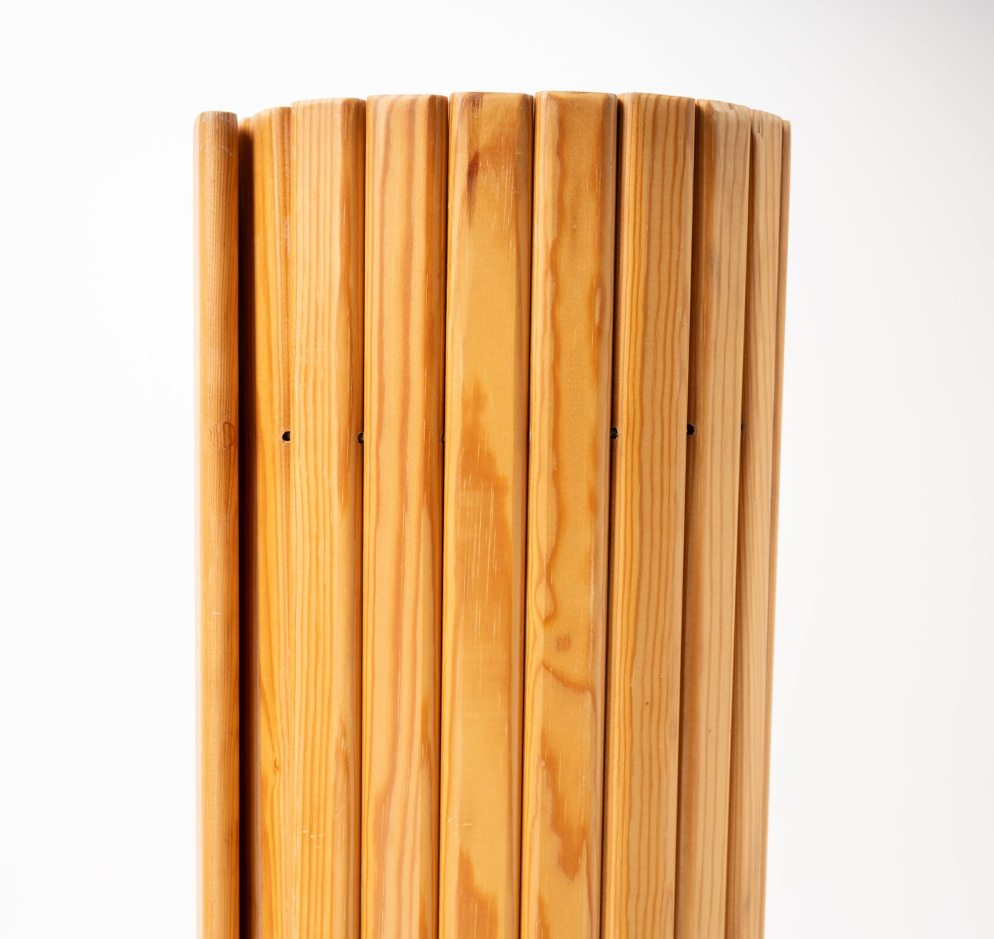 Close-up of Alvar Aalto 'Screen 100' room divider with vertical oversized pine slats and natural finish on white background