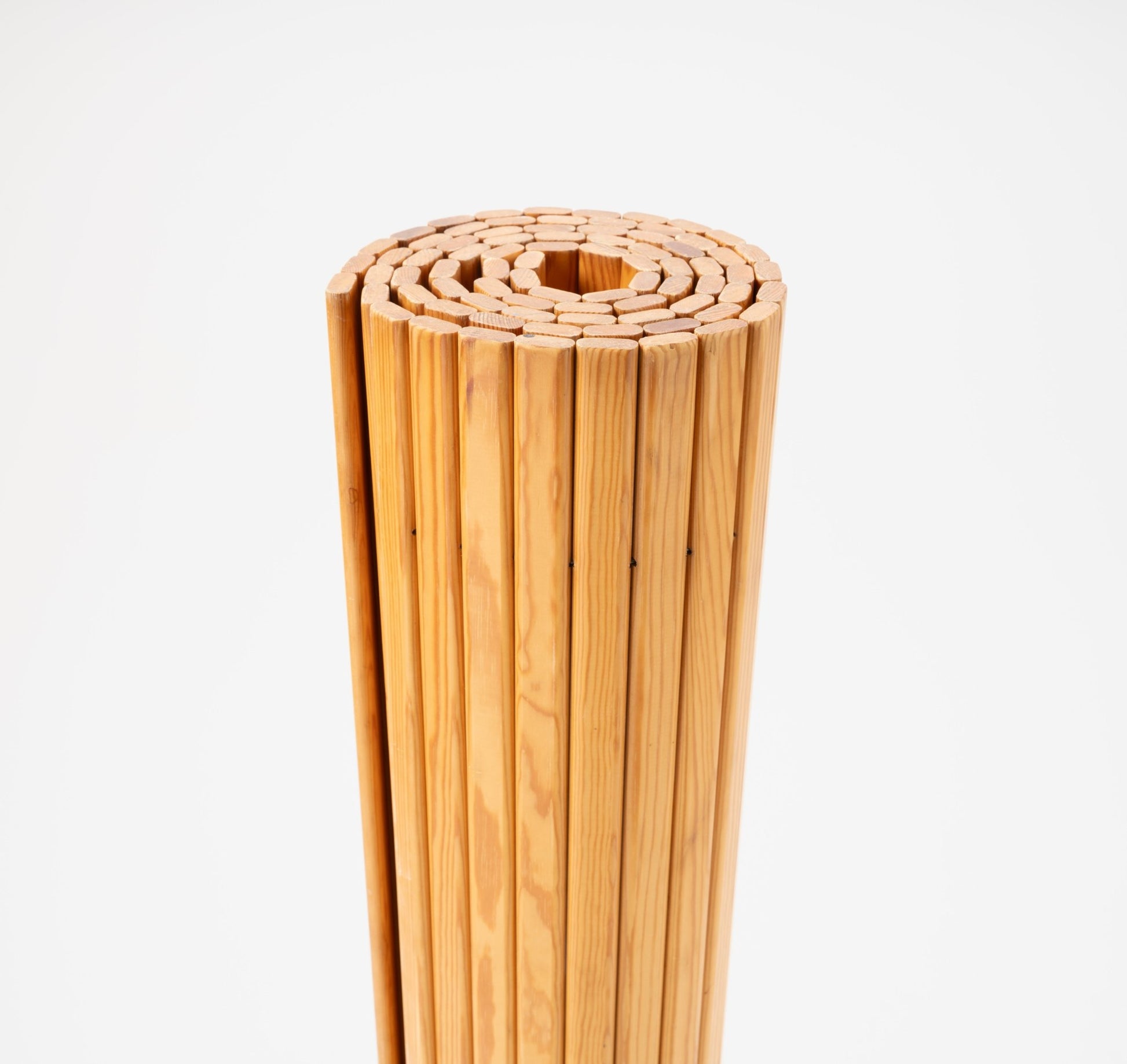 Rolled Alvar Aalto 'Screen 100' room divider made of vertical pine slats with natural wood finish on white background