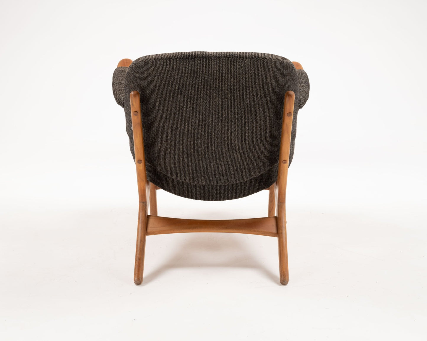 Arne Hovmand-Olsen chair from the 1950s with solid teak frame and dark upholstered winged backrest from Denmark.
