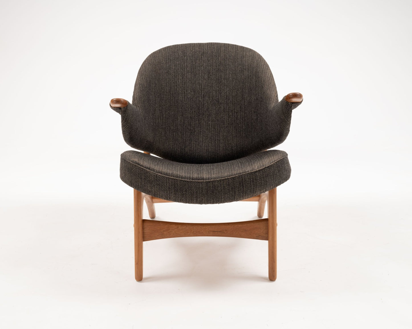Arne Hovmand-Olsen solid teak chair with winged backrest and armrests in dark upholstery, Danish 1950s design.