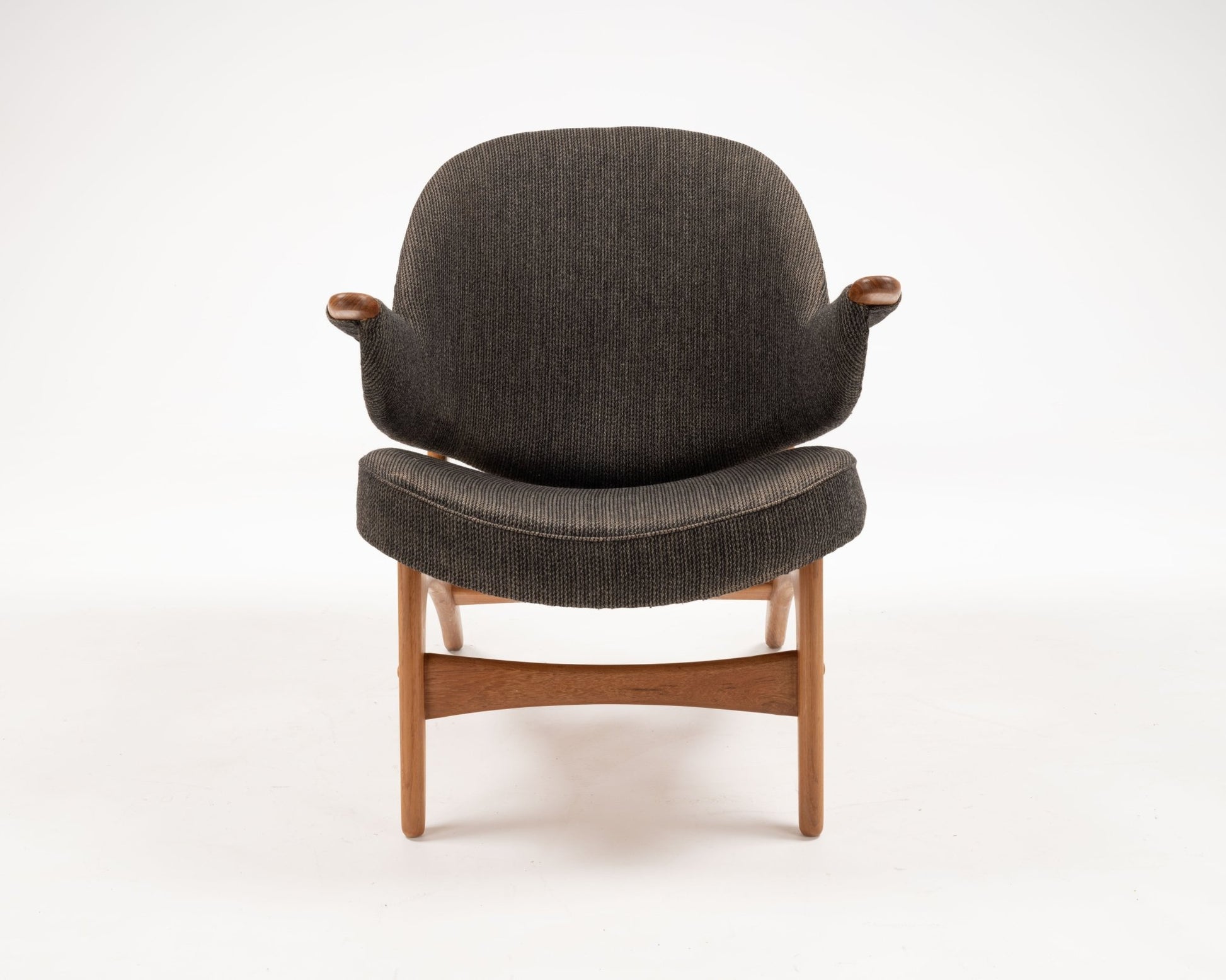 Arne Hovmand-Olsen solid teak chair with winged backrest and armrests in dark upholstery, Danish 1950s design.