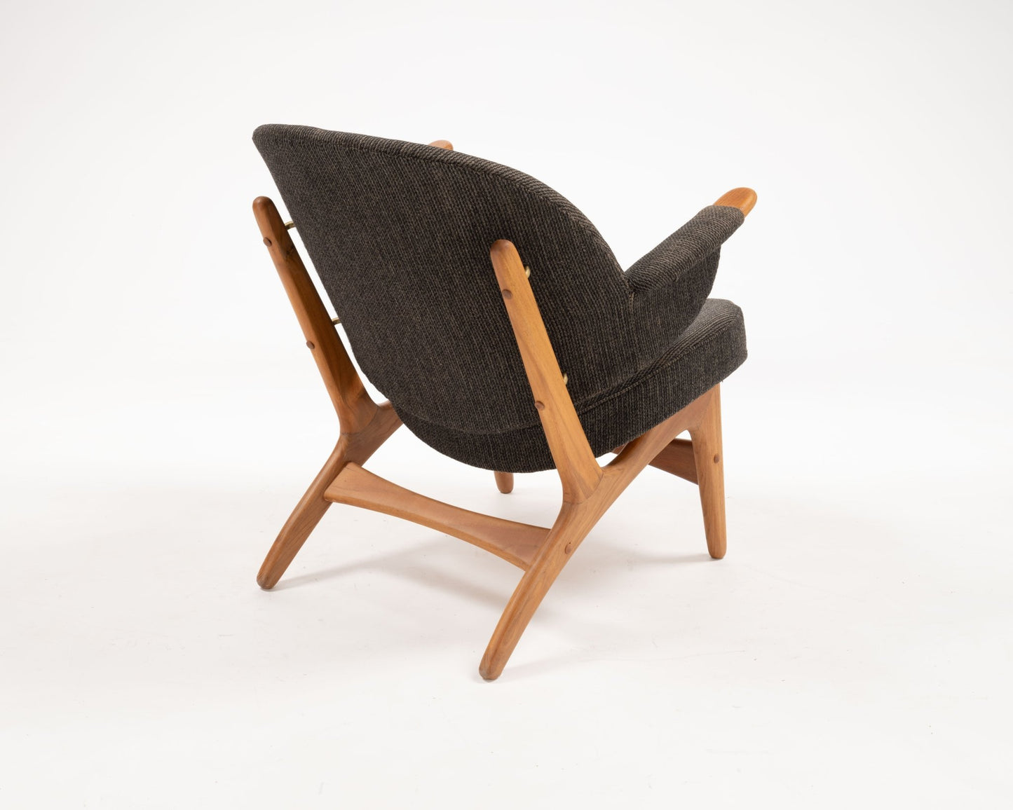 Arne Hovmand-Olsen solid teak lounge chair with winged backrest and dark upholstered seat from 1950s Denmark.