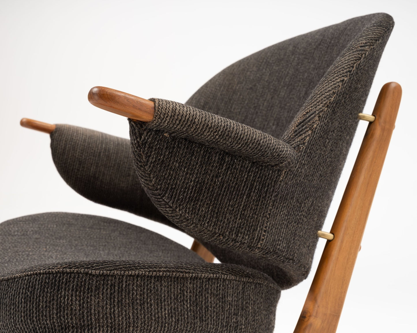 1950s Arne Hovmand-Olsen Danish chair in solid teak with winged backrest and dark upholstered fabric seat and arms