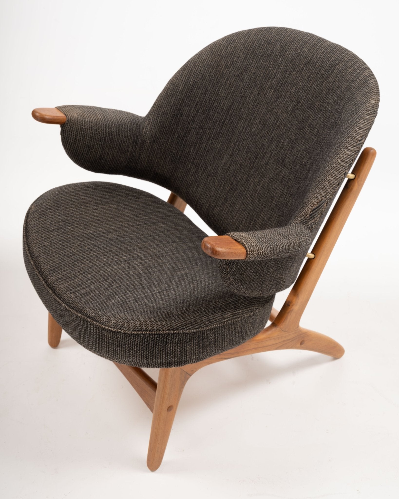 1950s Arne Hovmand-Olsen Danish chair in solid teak with winged backrest and dark upholstered seat and arms
