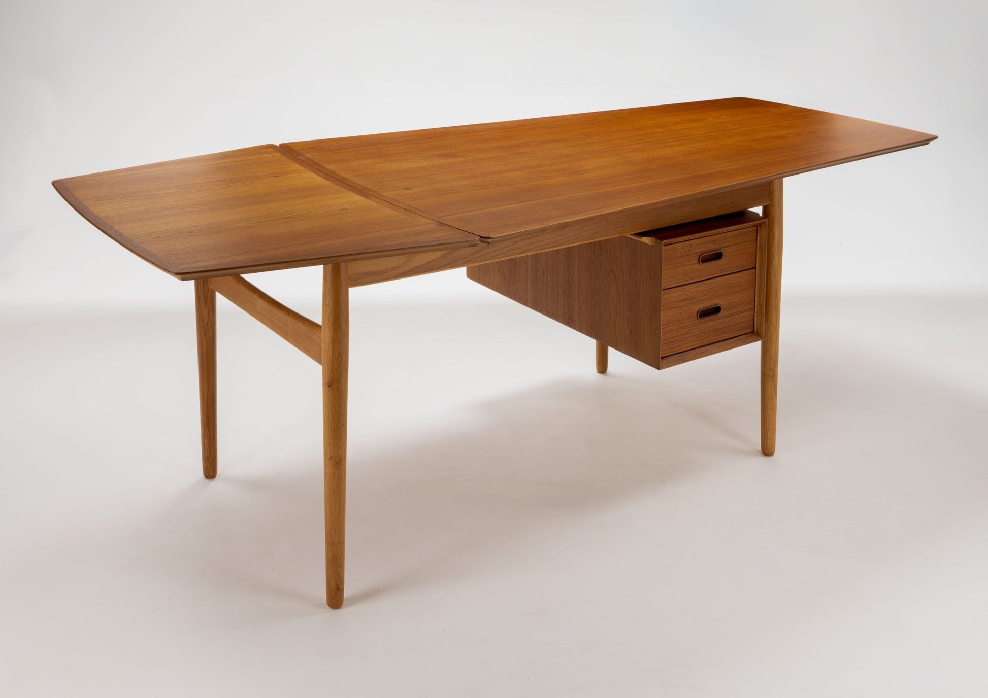 Mid-century modern teak drop leaf desk by Arne Vodder with tapered legs and two small drawers under the tabletop