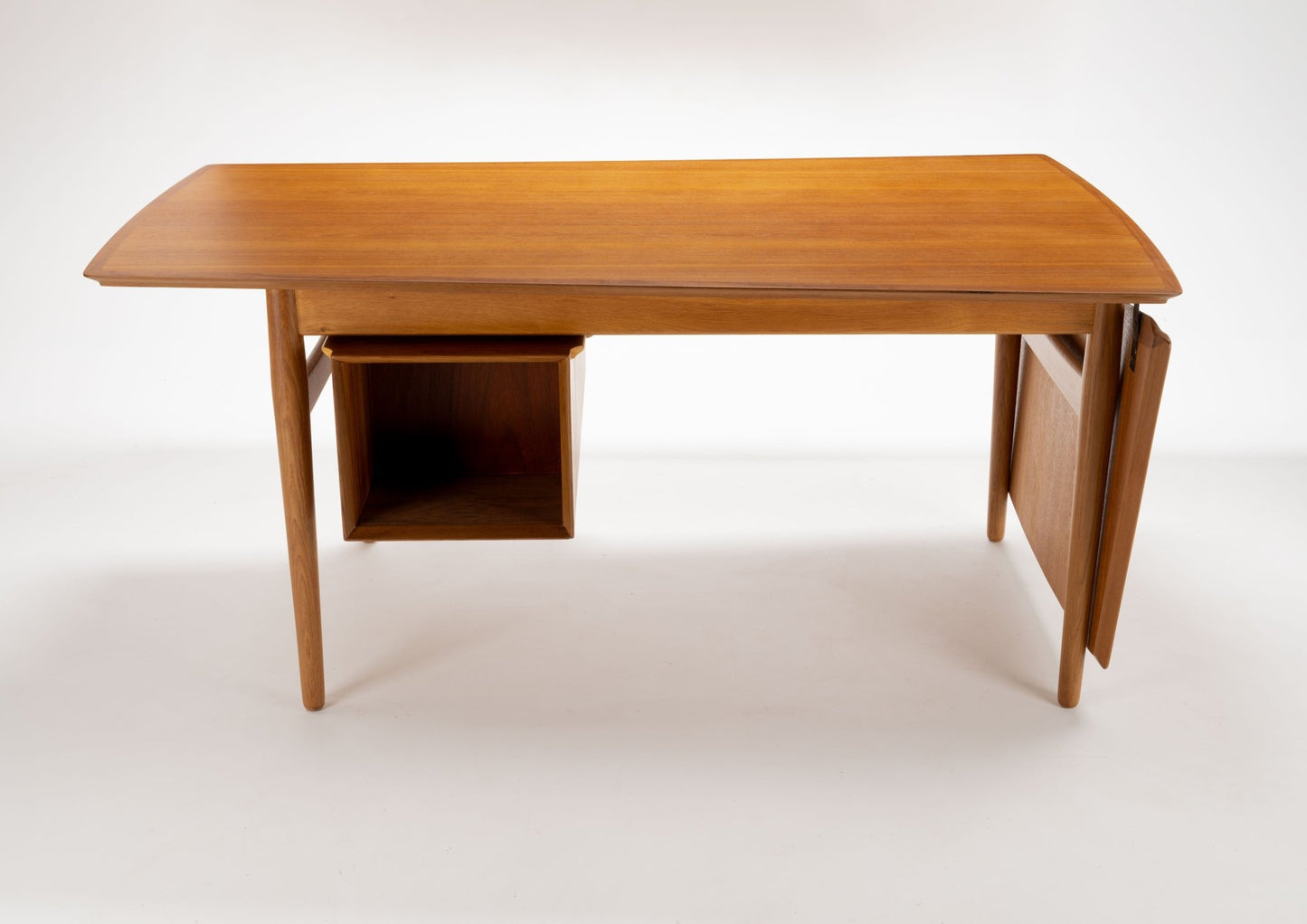 Mid-century modern Arne Vodder teak desk with hinged drop leaf and open storage compartment on white background
