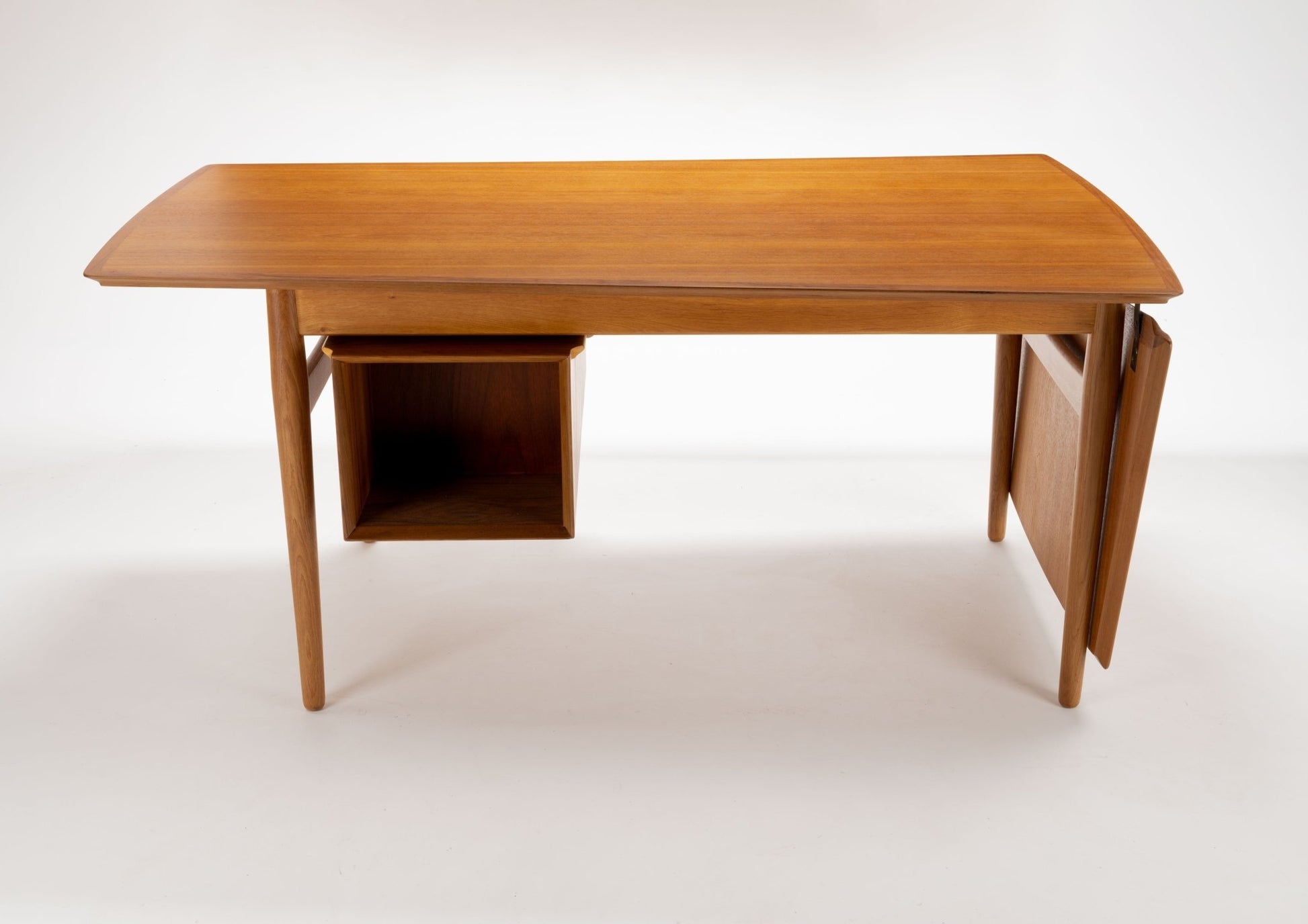 Mid-century modern Arne Vodder teak desk with hinged drop leaf and open storage compartment on white background