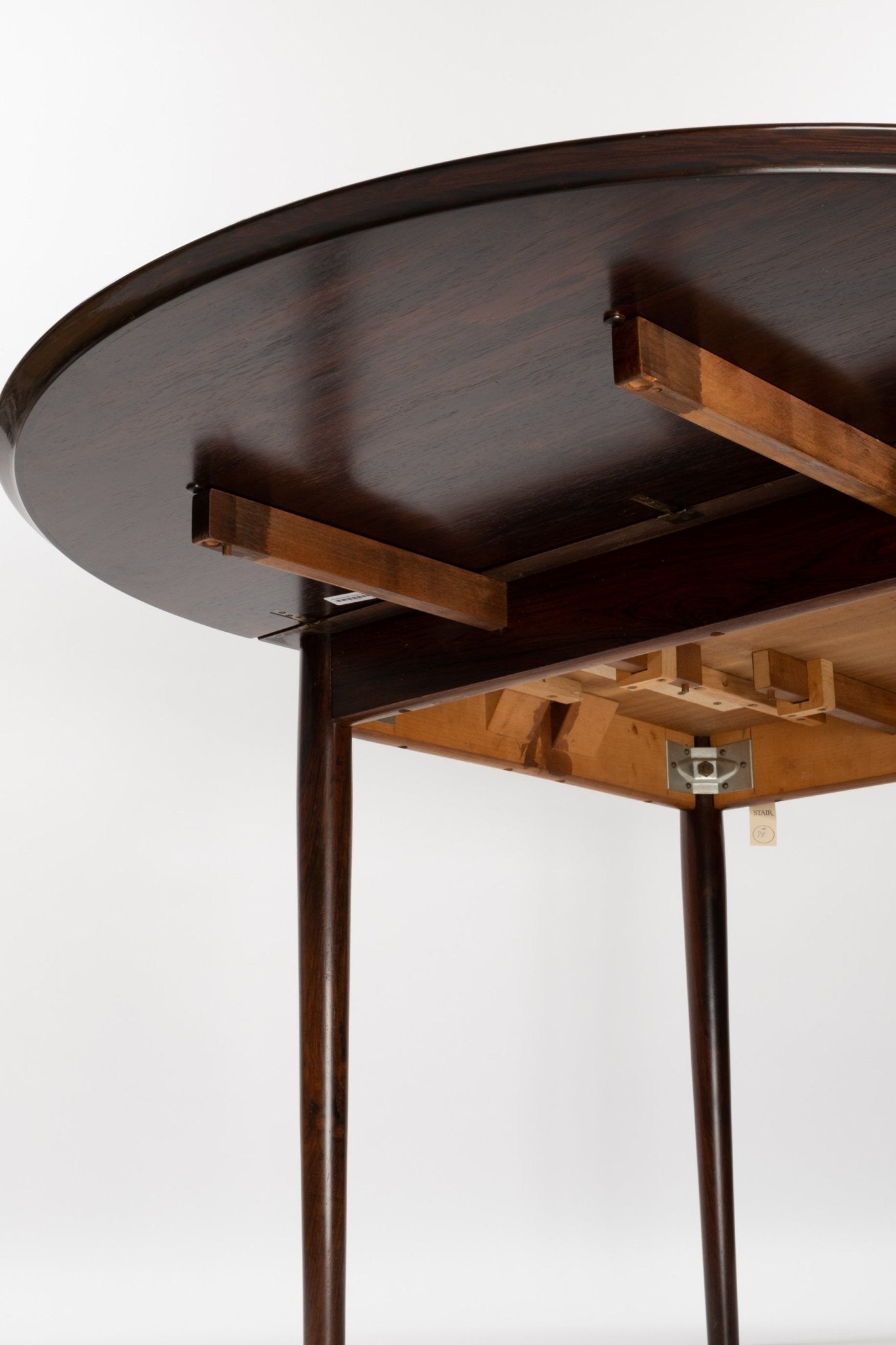 Underside view of mid-century modern Arne Vodder rosewood drop leaf dining table with tapered legs and extension mechanism
