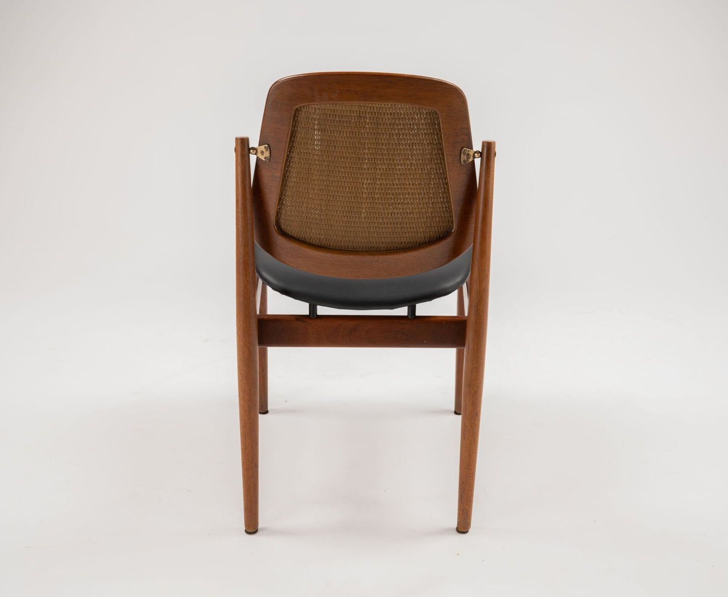 1950s Danish teak dining chair by Arne Vodder with sculpted frame, brass fittings, and woven backrest viewed from rear