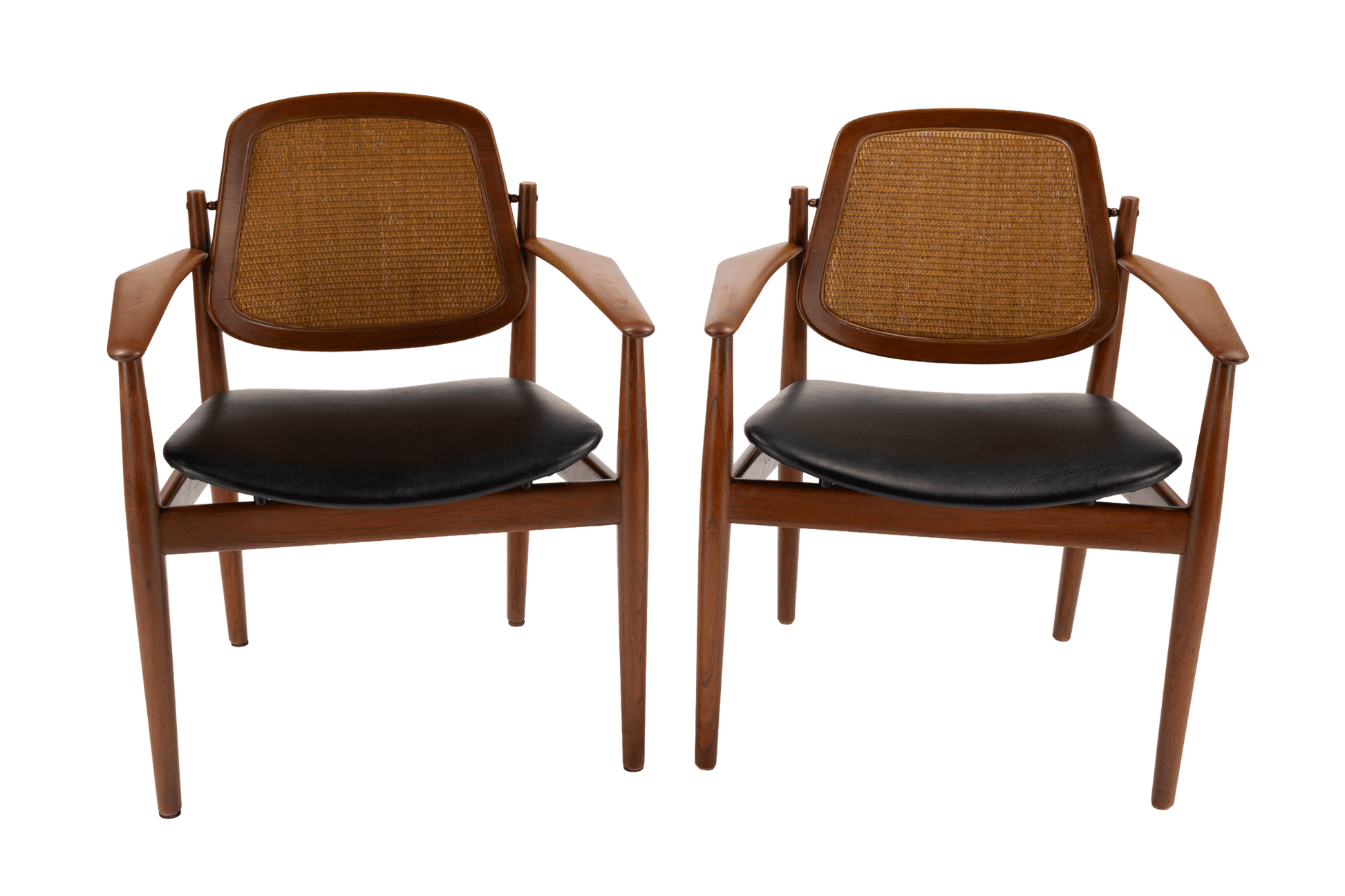 Pair of Arne Vodder 1950s Danish teak dining chairs with cane backrests and black leather seats on white background