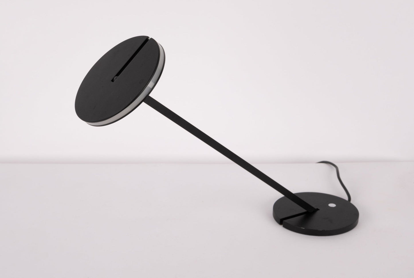 Pair of black Artemide Itis LED table lamps with adjustable heads and minimalist Italian design on white background