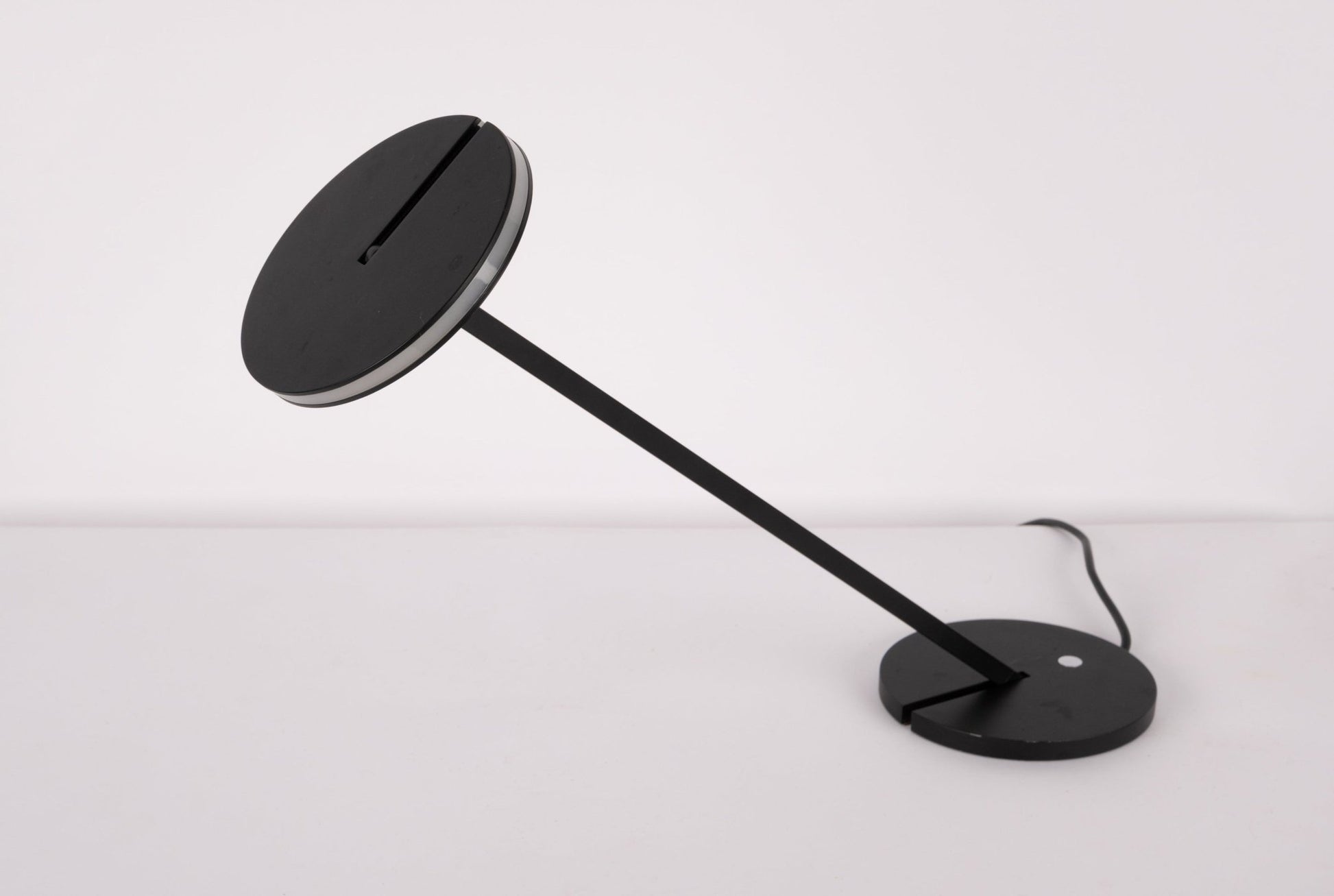 Pair of black Artemide Itis LED table lamps with adjustable heads and minimalist Italian design on white background