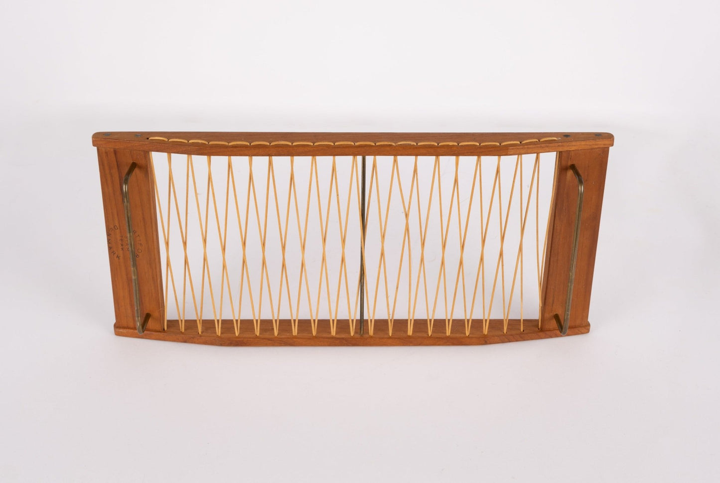 Danish mid-century modern teak bread tray with woven rattan center and brass hardware on frame edges