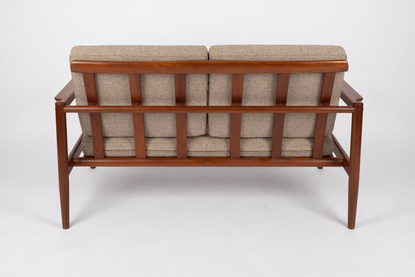 Back view of 1960s Borge Jensen teak settee with slatted frame and beige upholstered Hallingdal wool seat cushions