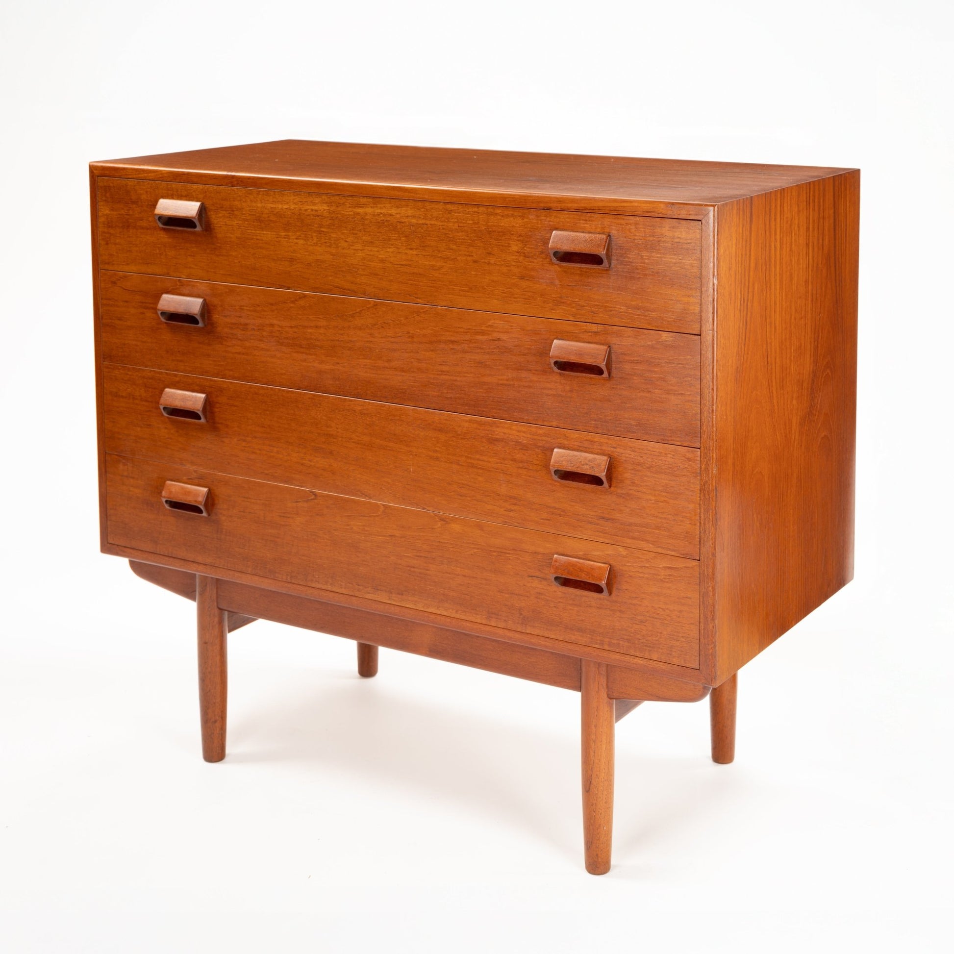 Three-drawer wooden chest with minimalist rectangular wooden handles and tapered legs in warm mid-century finish