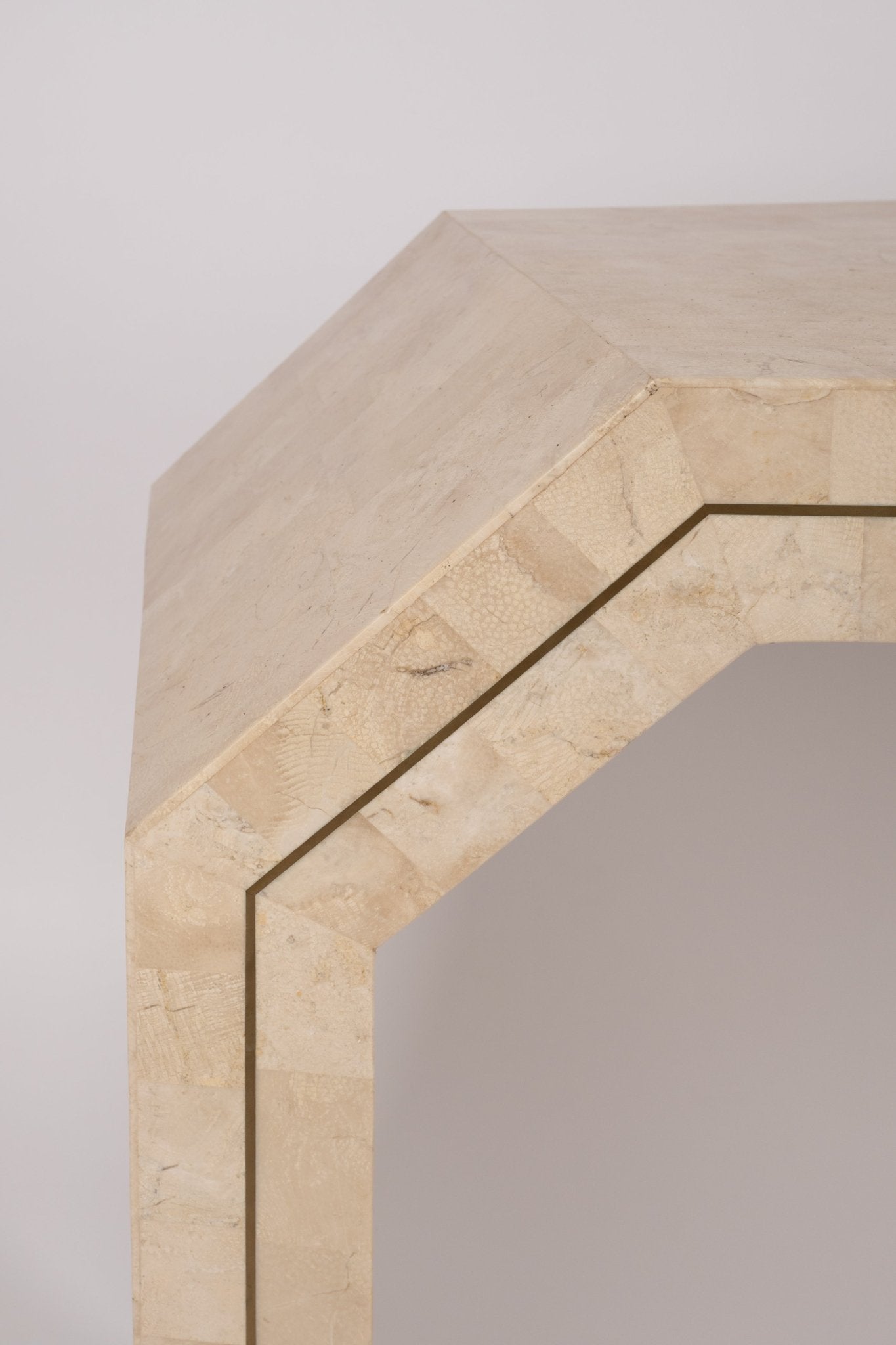 Close-up of 1980s Casa Bique tessellated marble console table edge with brass inlay and brick pattern surface