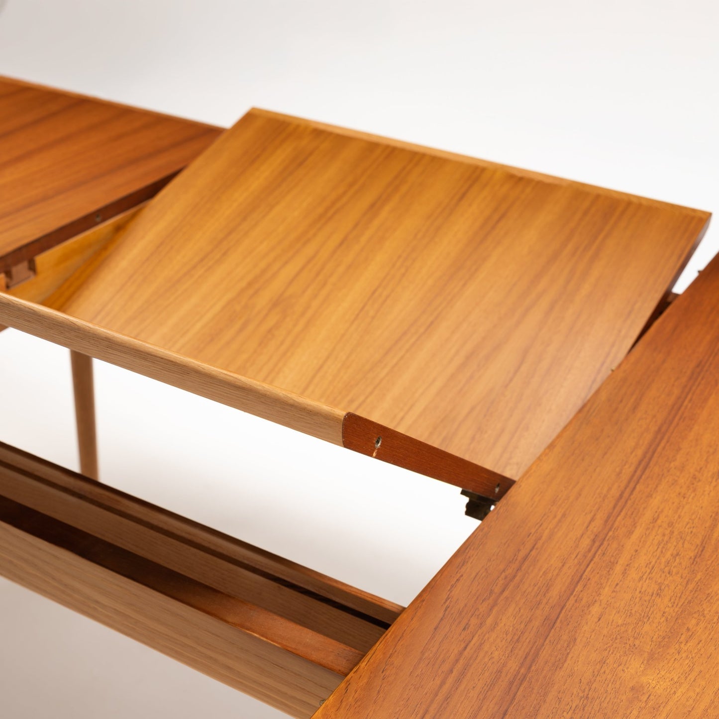 Danish Butterfly-Leaf Teak Dining Table shown open with butterfly leaf extension and rich teak wood grain in vintage Danish furniture style