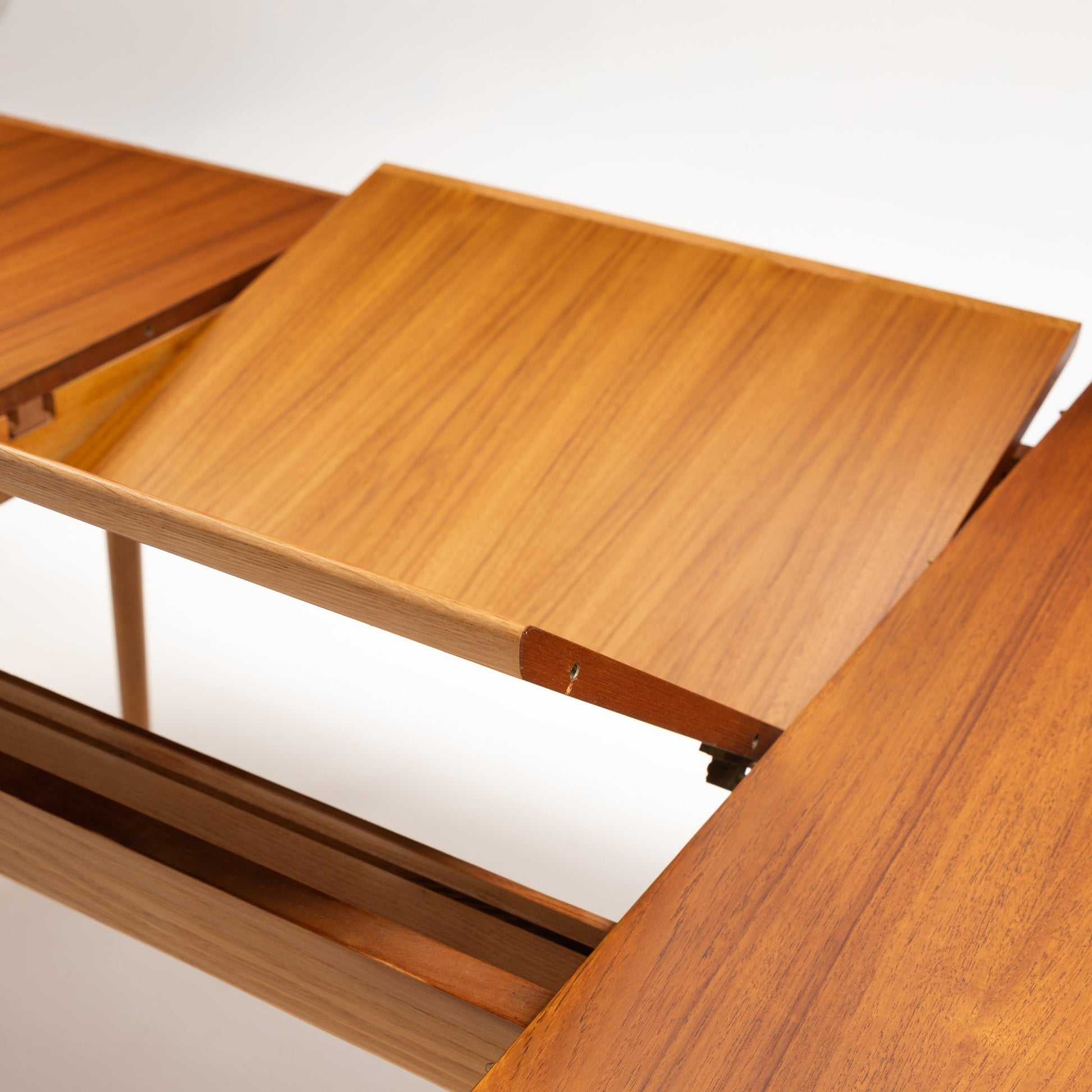 Danish Butterfly-Leaf Teak Dining Table shown open with butterfly leaf extension and rich teak wood grain in vintage Danish furniture style