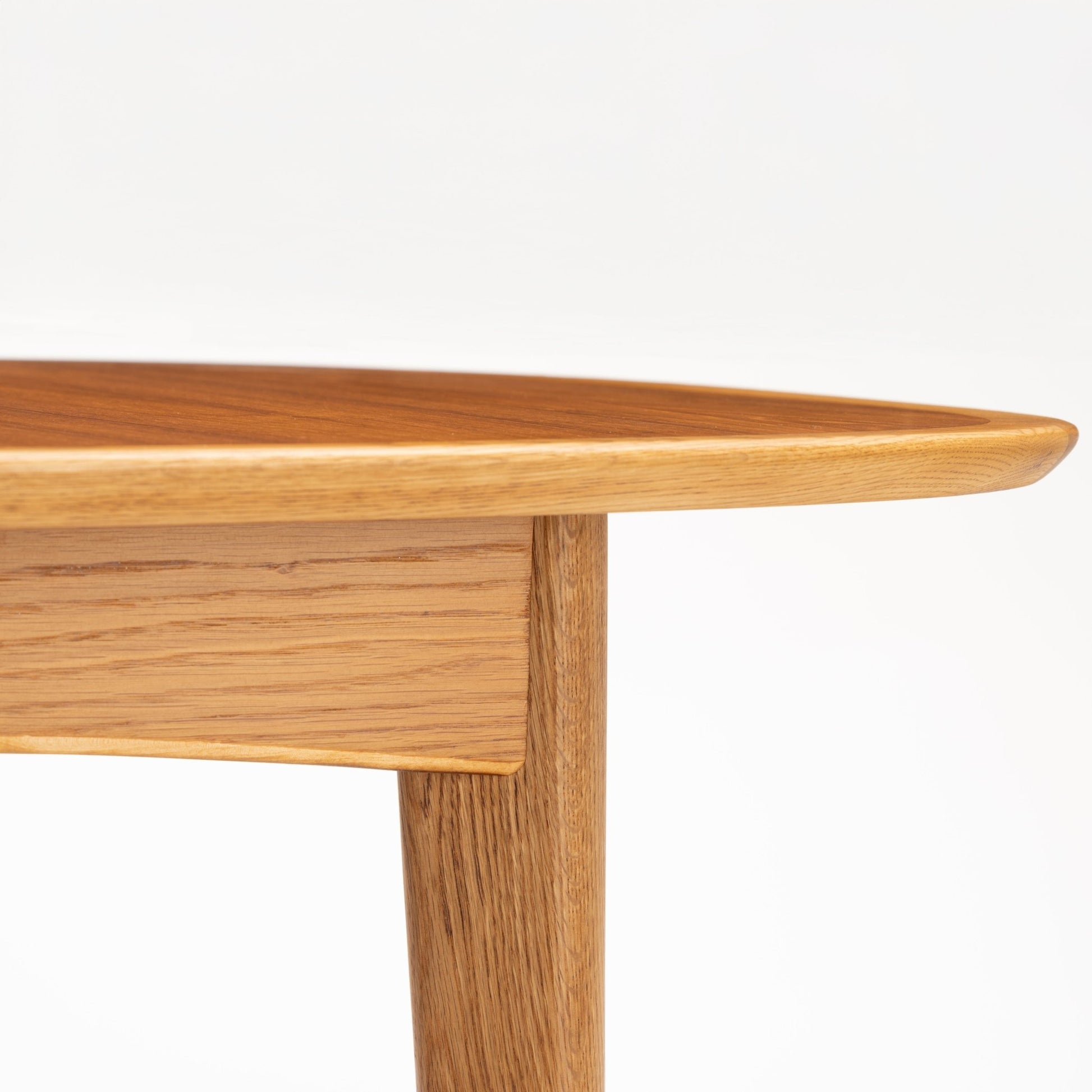 Danish Butterfly-Leaf Teak Dining Table detail showing rounded edge tabletop apron and tapered leg with rich wood grain in vintage Danish furniture style