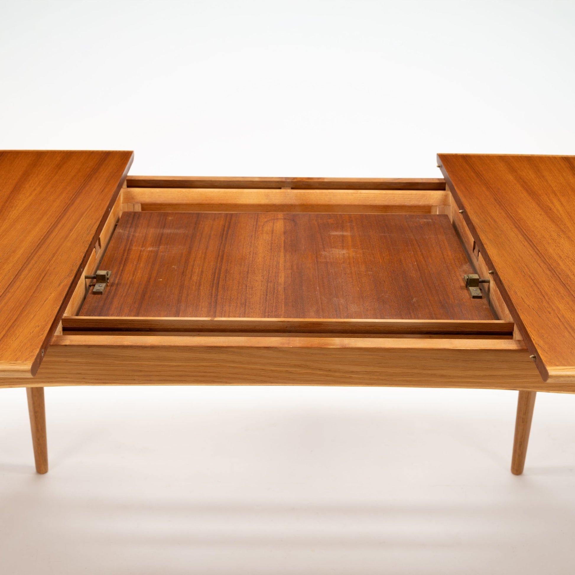Danish Butterfly-Leaf Teak Dining Table shown open with butterfly extension leaves rich wood grain and tapered legs in mid century modern furniture style