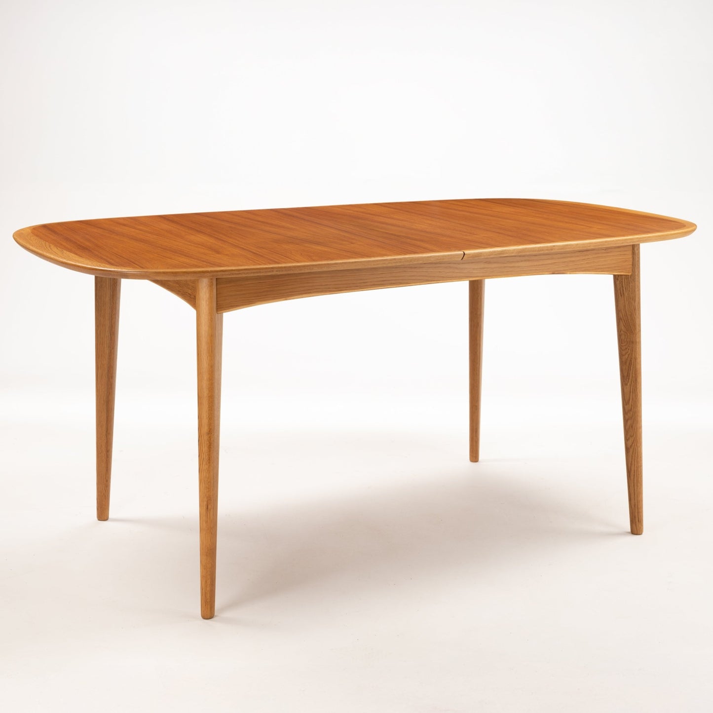Danish Butterfly-Leaf Teak Dining Table with oval extension top tapered legs and warm wood grain in vintage Danish furniture style