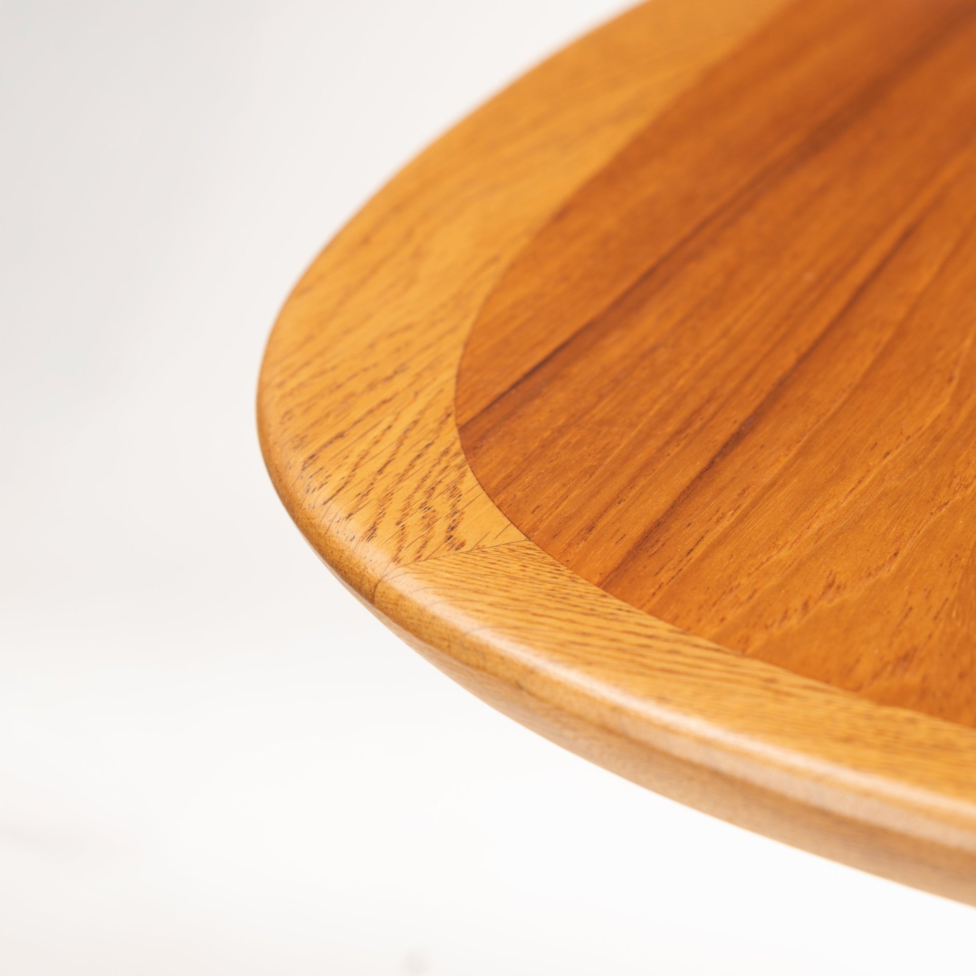 Danish Butterfly-Leaf Teak Dining Table closeup showing rounded edge tabletop rich teak grain and crafted joinery in vintage Danish furniture style