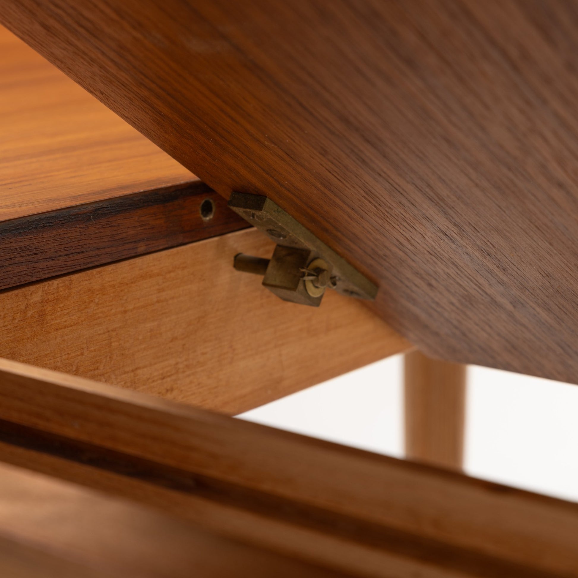 Danish Butterfly-Leaf Teak Dining Table underside detail showing butterfly leaf hinge hardware warm wood grain and construction in vintage Danish furniture style