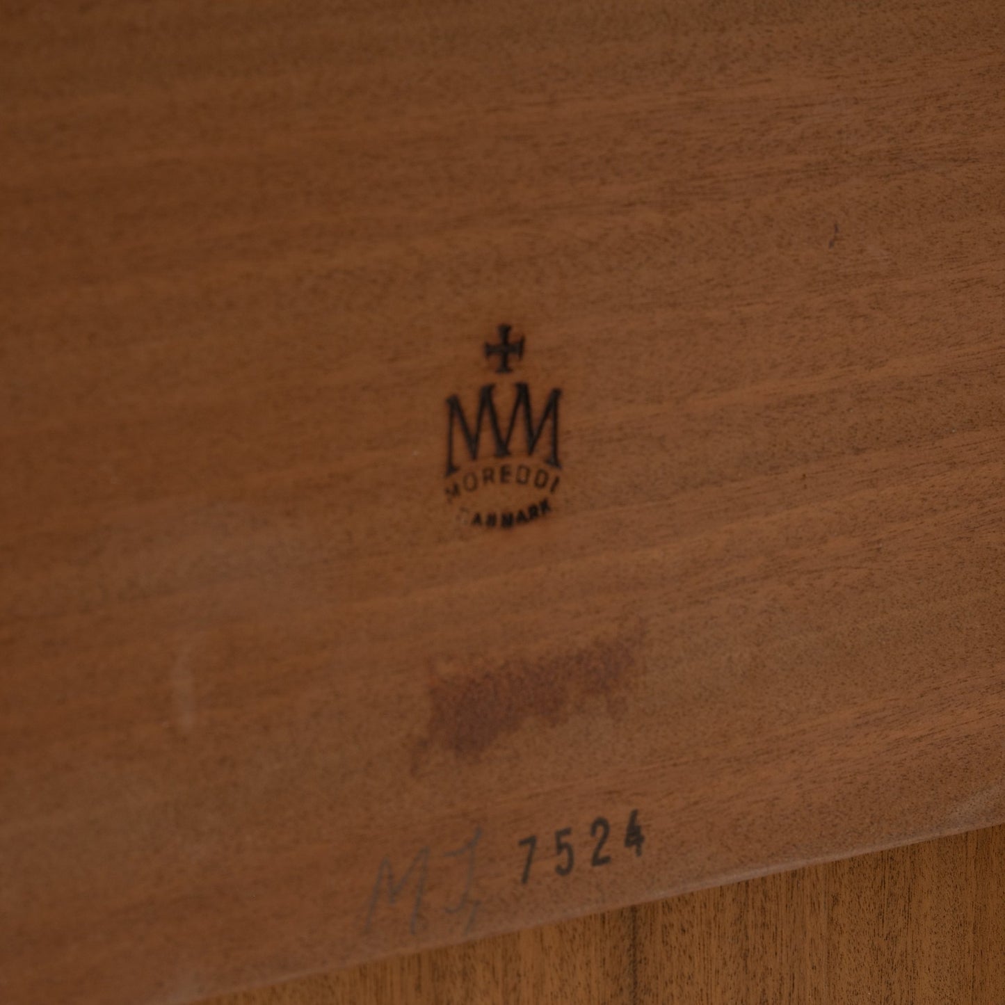 Danish Draw-Leaf Dining Table in Teak showing warm wood grain beneath the tabletop with a stamped maker mark and handwritten number